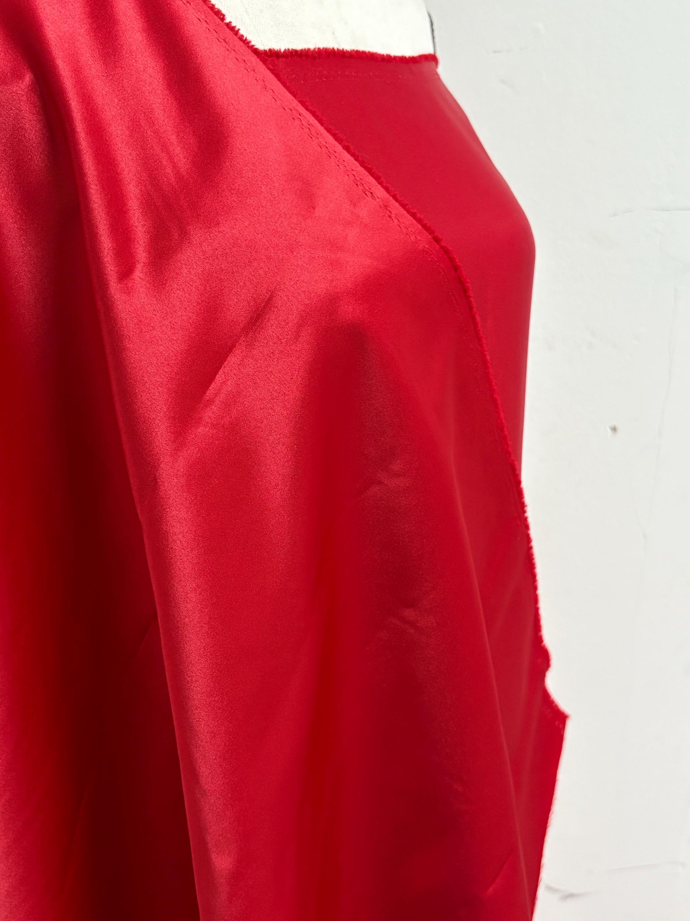 A 2 yards cut fantasy satin width 60", 100% polyester color red suitable for dress. sell by 2 yards increment continuous. Known as L'Amour