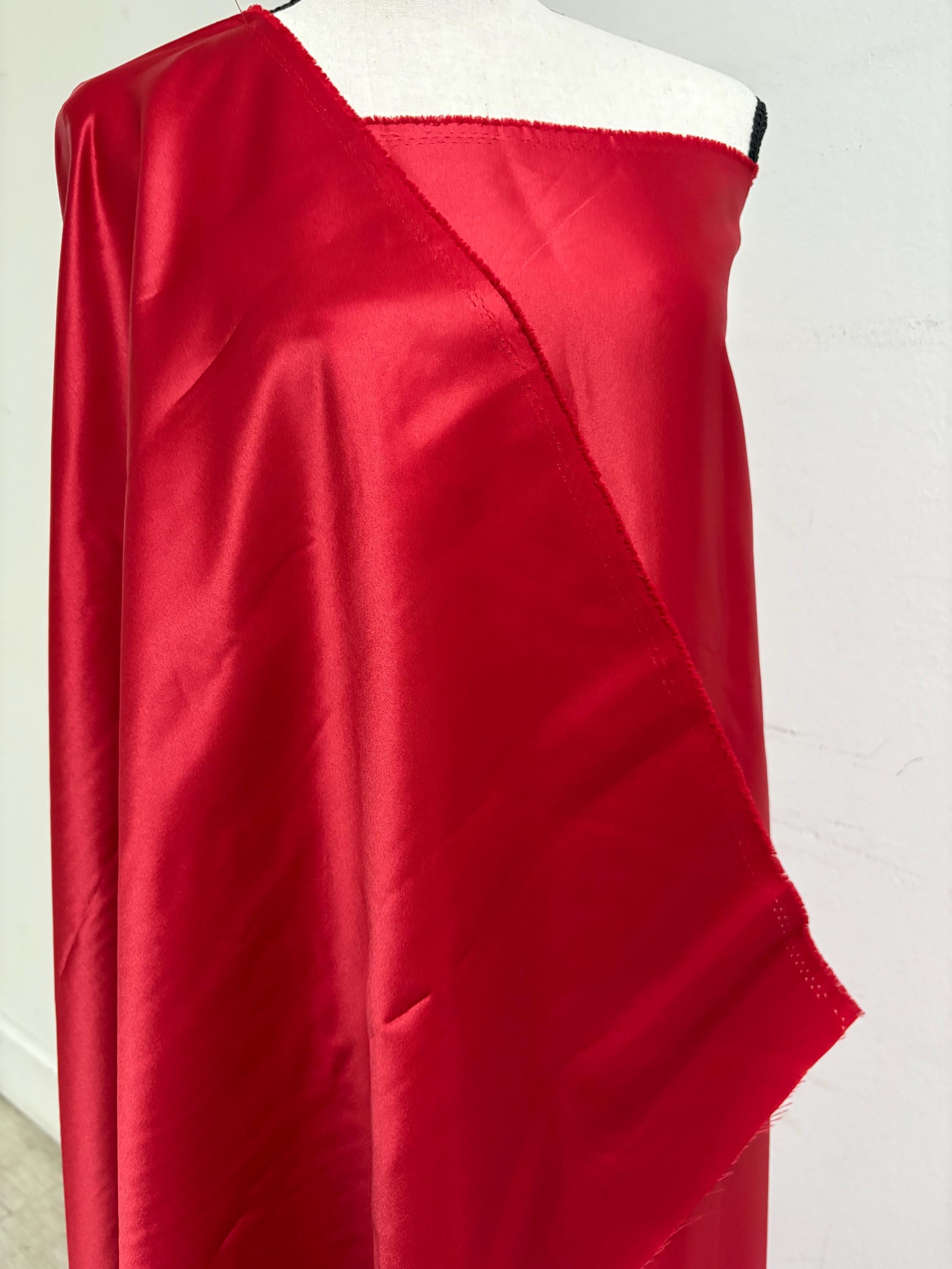 A 2 yards cut fantasy satin width 60", 100% polyester color red suitable for dress. sell by 2 yards increment continuous. Known as L'Amour