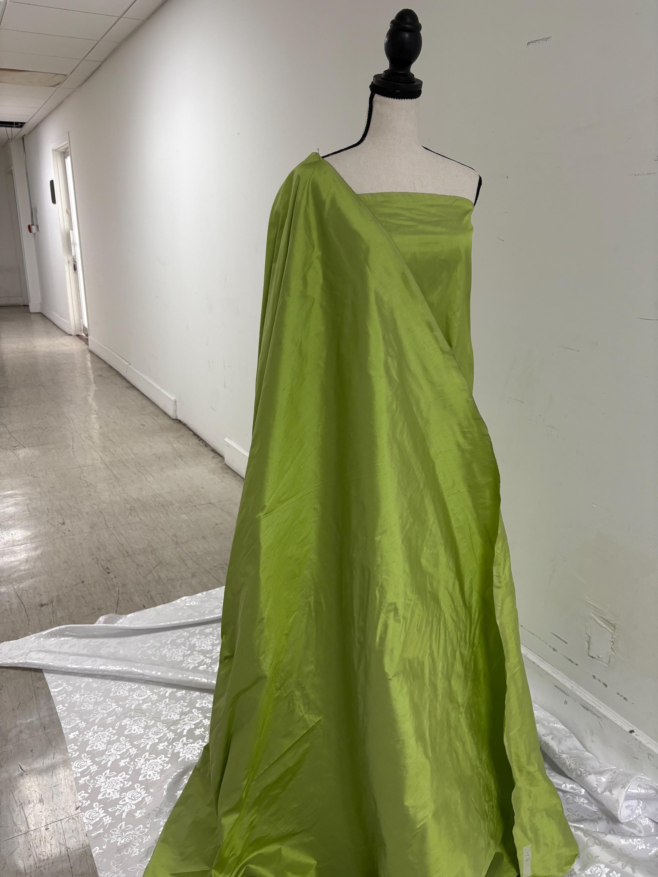 100% silk Dupioni Taffeta width 54" color is two tone Olive with black tone. Machine made, fabric has slubs. Item # 3. free sample.