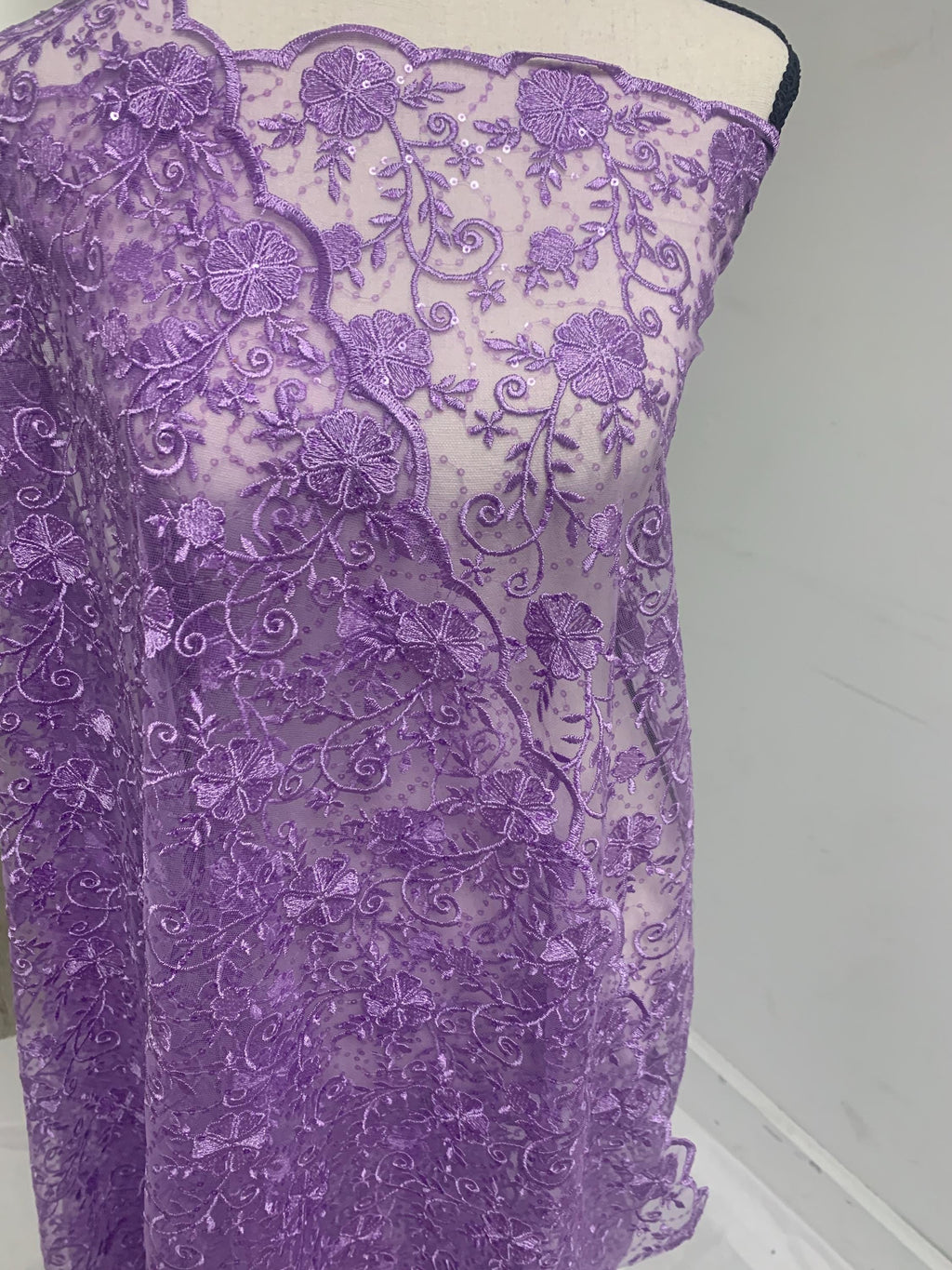 A 3-yard cut of Lilac Lace fabric with a width of 49/50 inches, featuring double scalloped embroidery and sequins. Design code: 04331279.