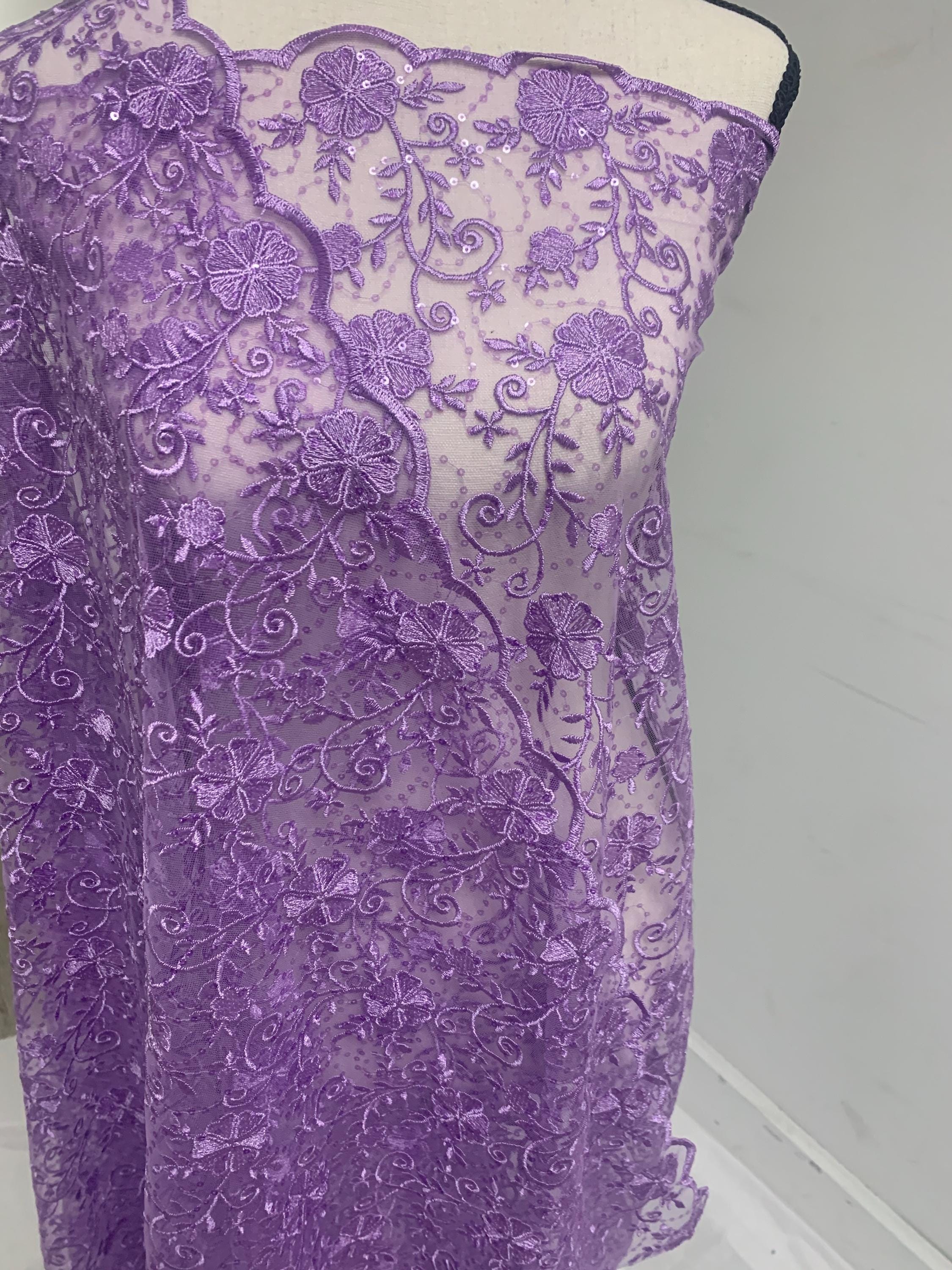 A 3-yard cut of Lilac Lace fabric with a width of 49/50 inches, featuring double scalloped embroidery and sequins. Design code: 04331279.