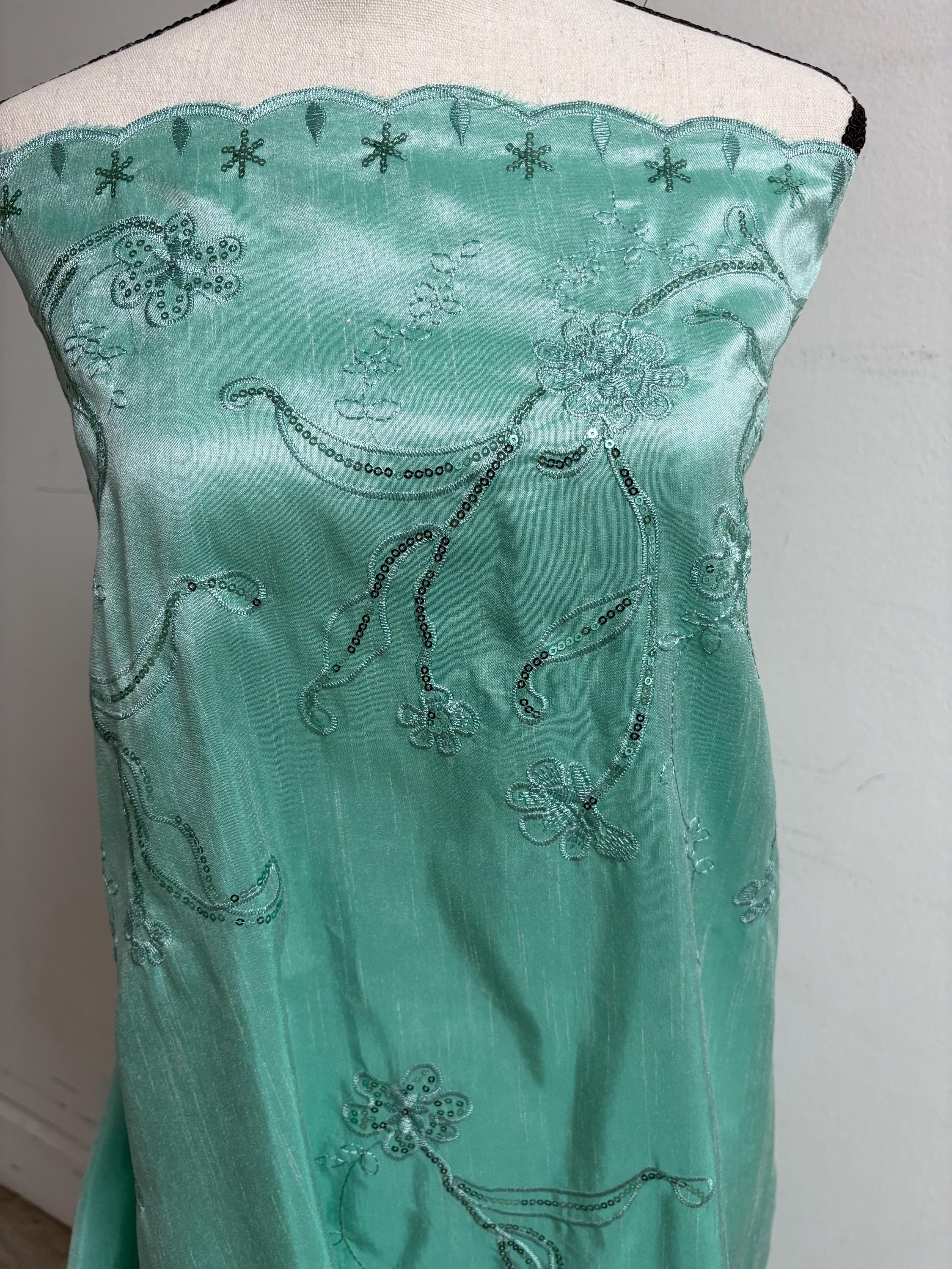 A 3 yards Tiffany satin Shantung Fabric width 58 inches polyester. Double scalloped sequins embroidery with slubbed texture.