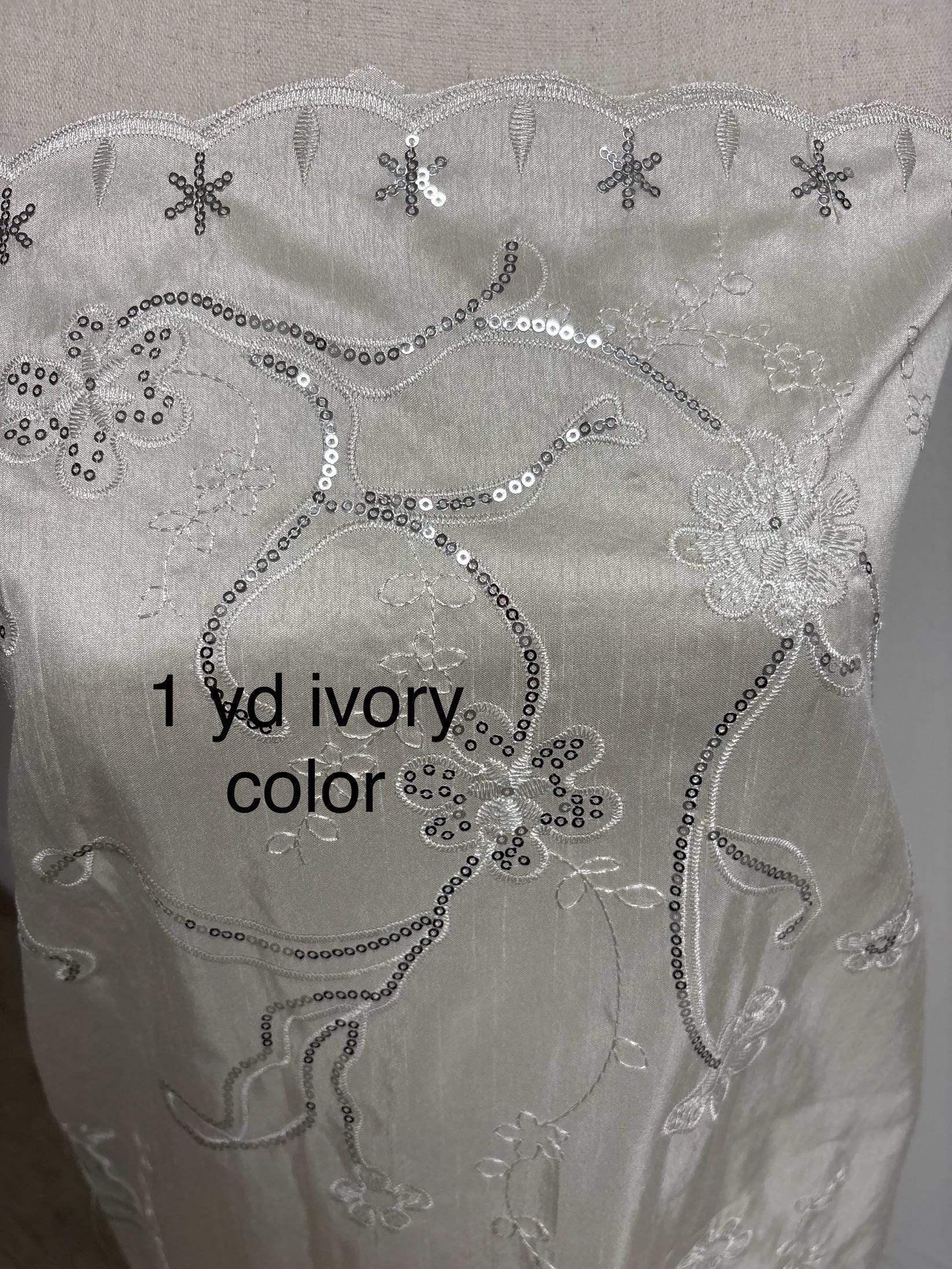 A 3 yards Ivory satin Shantung Fabric width 58 inches polyester. Double scalloped sequins embroidery with slubbed texture.