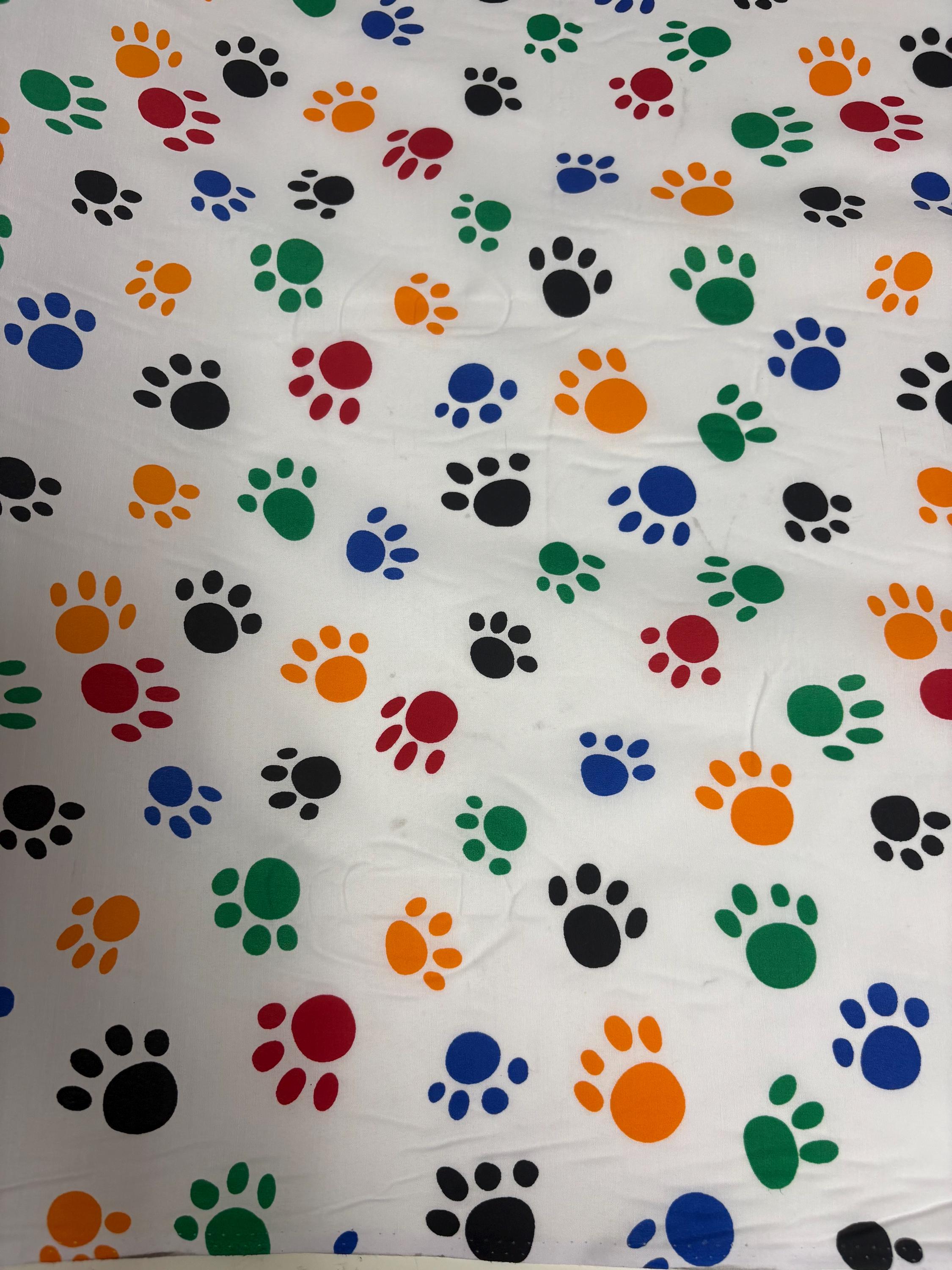 A 2 yard cut Paws print fabric, width 58/60" polyester fabric in Multi color, shirt weight. kids crafts. sold by 2 yards and cut continuous.