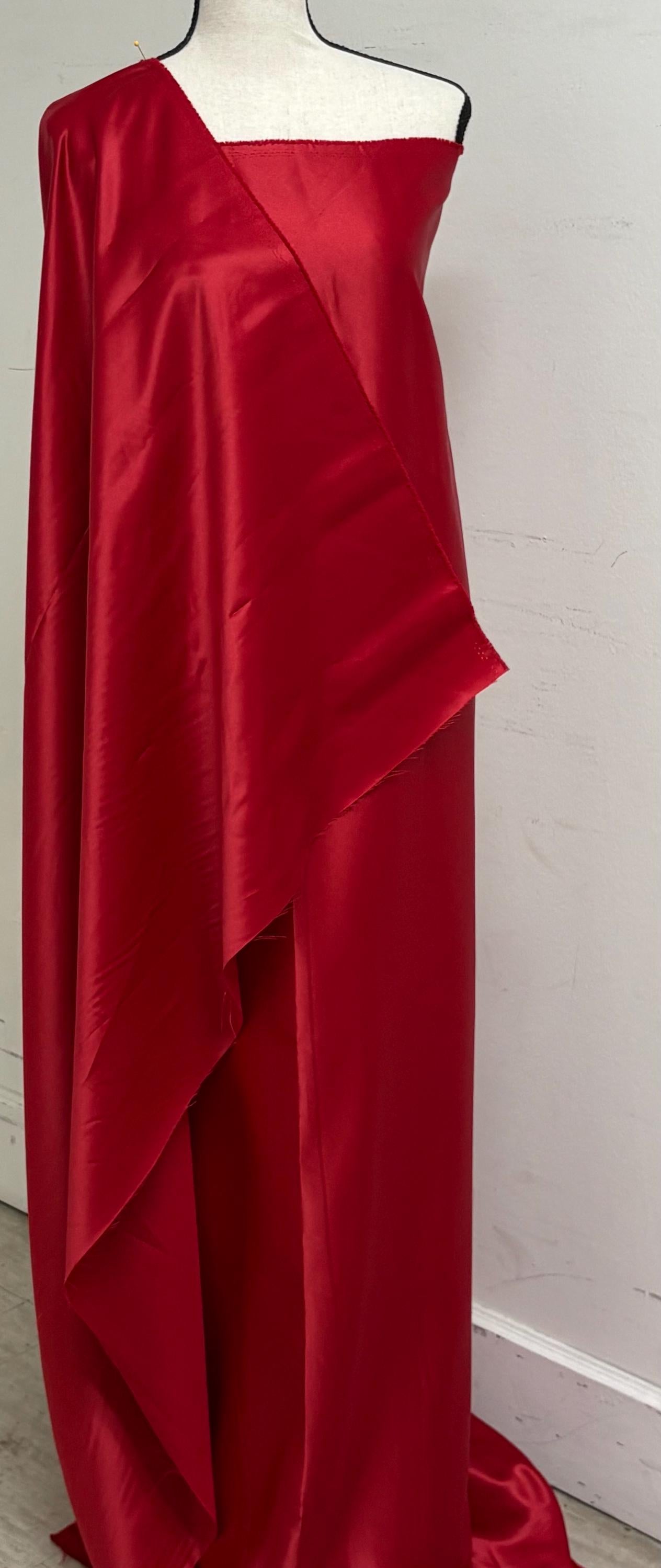 A 2 yards cut fantasy satin width 60", 100% polyester color red suitable for dress. sell by 2 yards increment continuous. Known as L'Amour