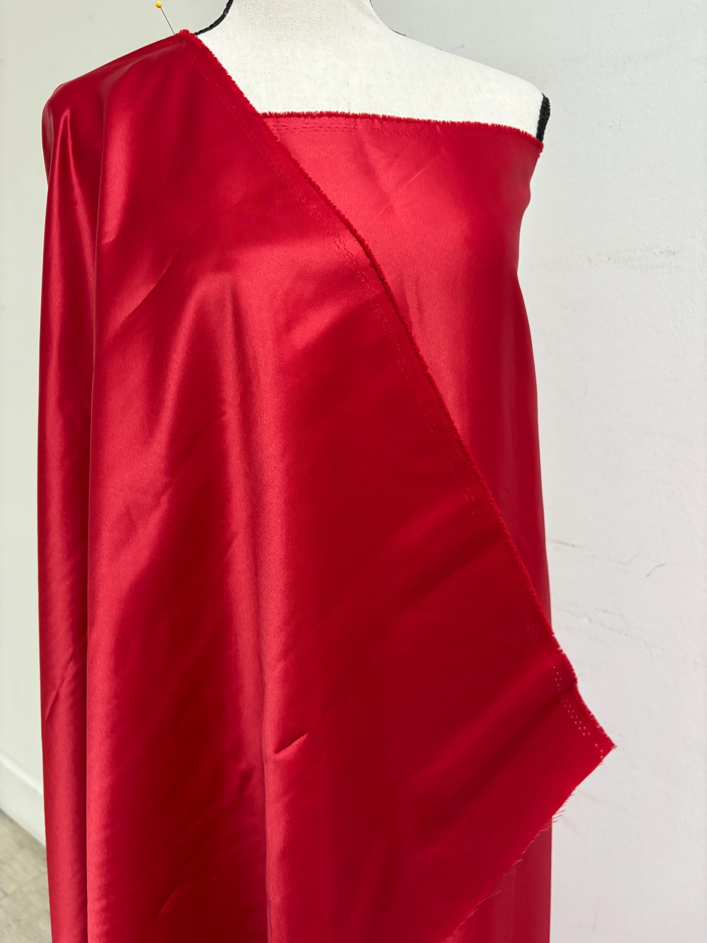 A 2 yards cut fantasy satin width 60", 100% polyester color red suitable for dress. sell by 2 yards increment continuous. Known as L'Amour