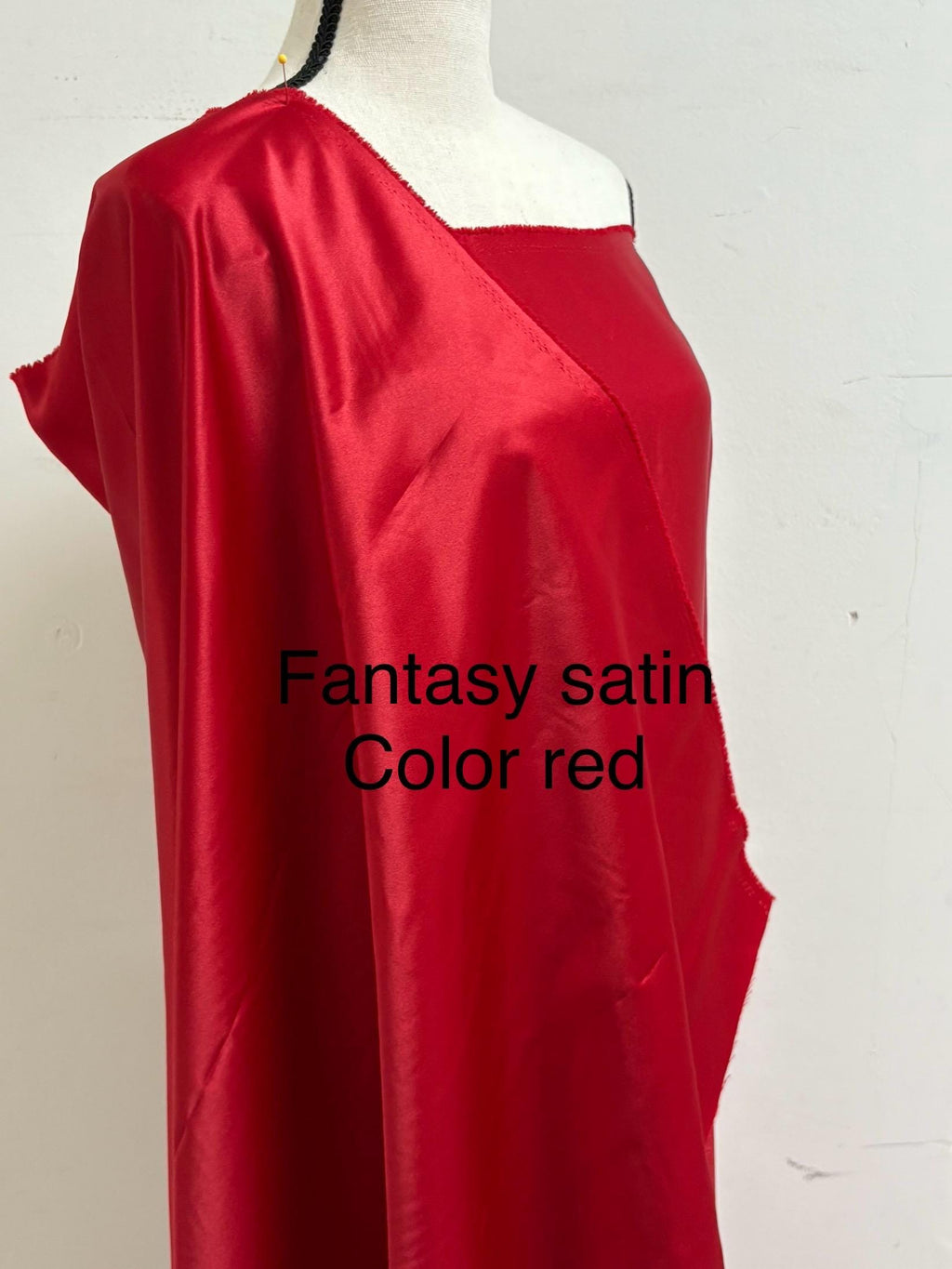 A 2 yards cut fantasy satin width 60", 100% polyester color red suitable for dress. sell by 2 yards increment continuous. Known as L'Amour