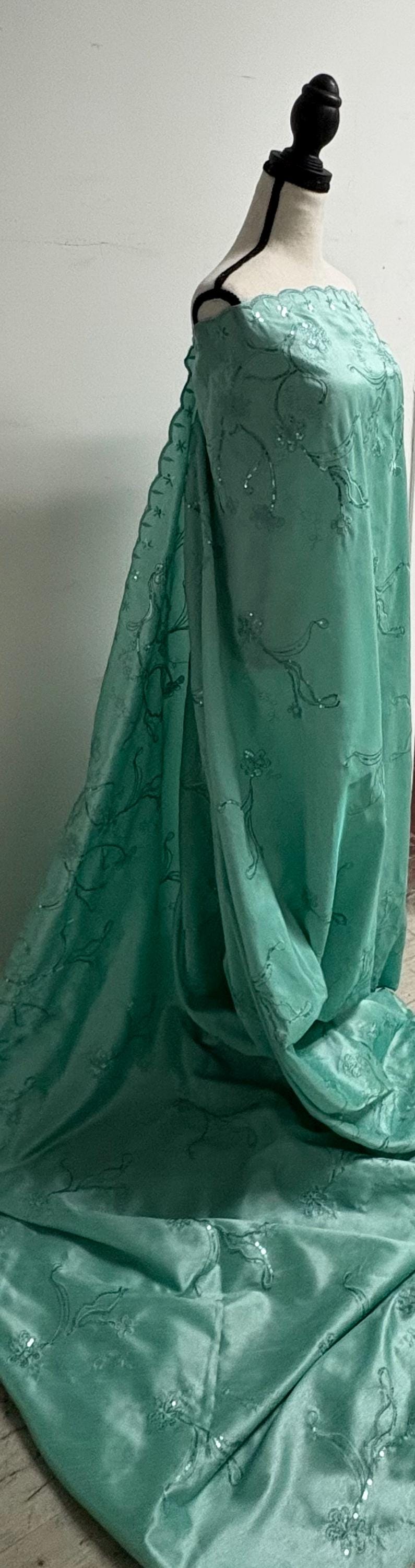 A 3 yards Tiffany satin Shantung Fabric width 58 inches polyester. Double scalloped sequins embroidery with slubbed texture.