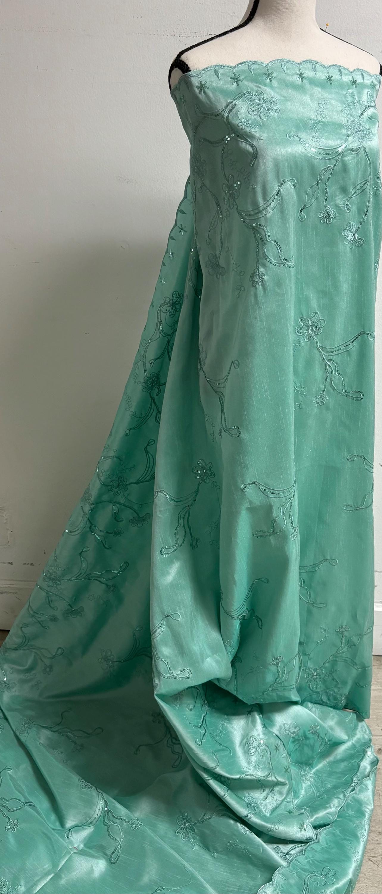 A 3 yards Tiffany satin Shantung Fabric width 58 inches polyester. Double scalloped sequins embroidery with slubbed texture.