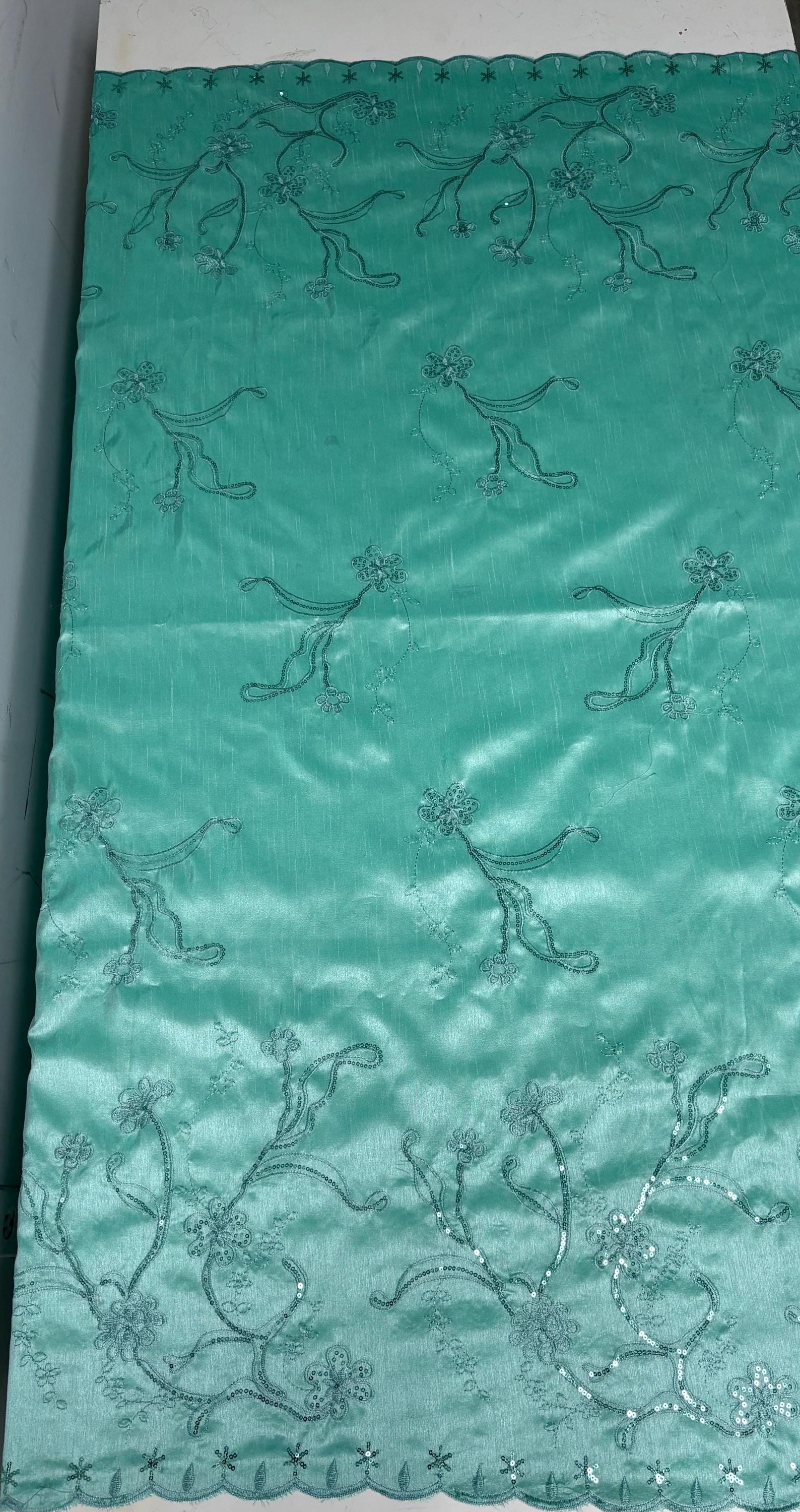 A 3 yards Tiffany satin Shantung Fabric width 58 inches polyester. Double scalloped sequins embroidery with slubbed texture.
