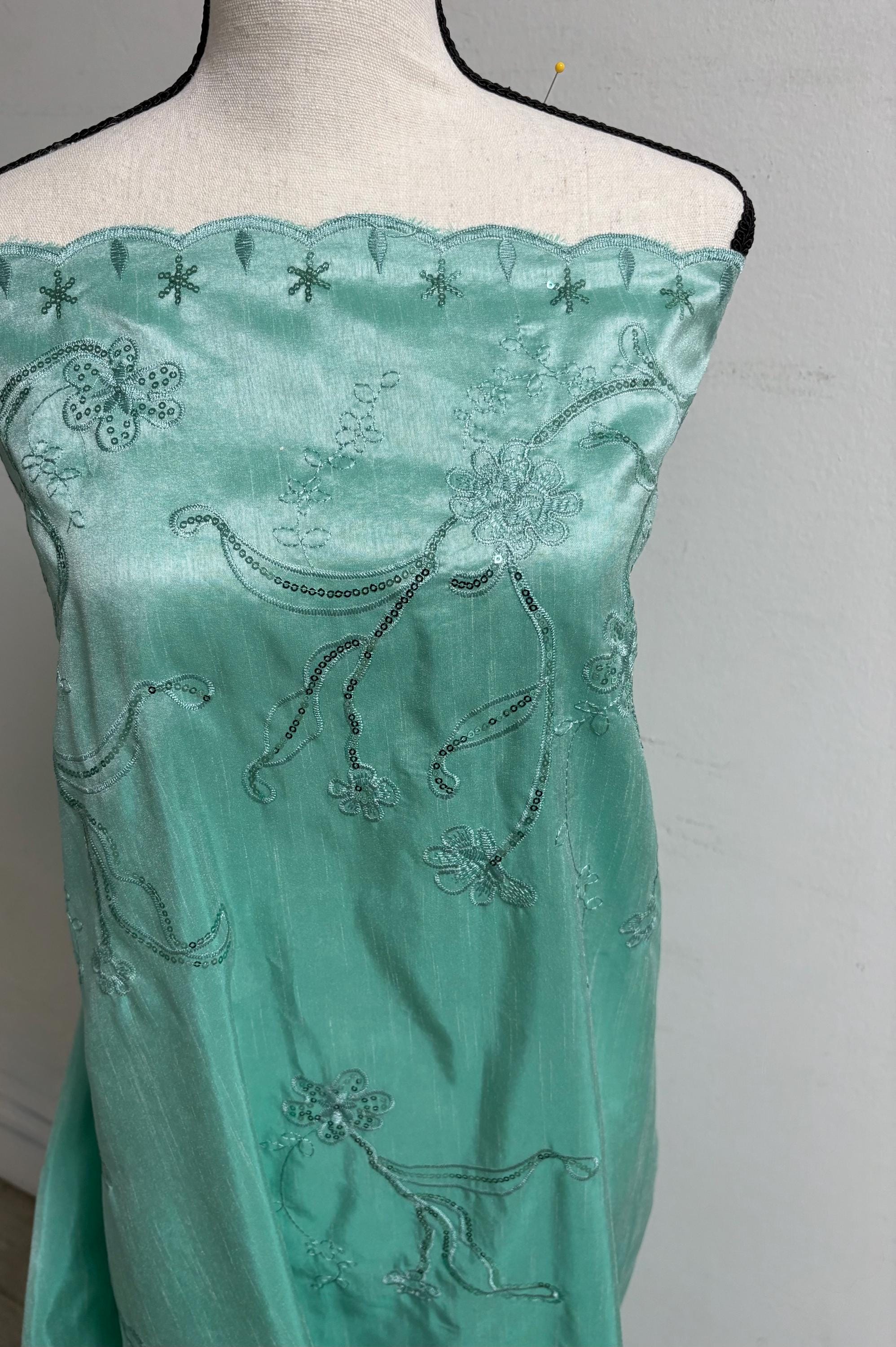 A 3 yards Tiffany satin Shantung Fabric width 58 inches polyester. Double scalloped sequins embroidery with slubbed texture.