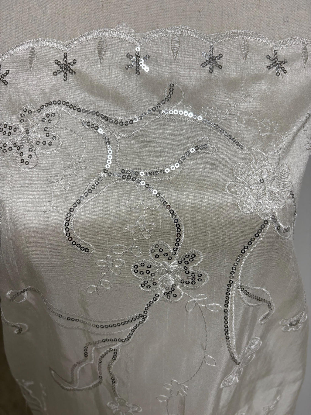 A 3 yards Ivory satin Shantung Fabric width 58 inches polyester. Double scalloped sequins embroidery with slubbed texture.