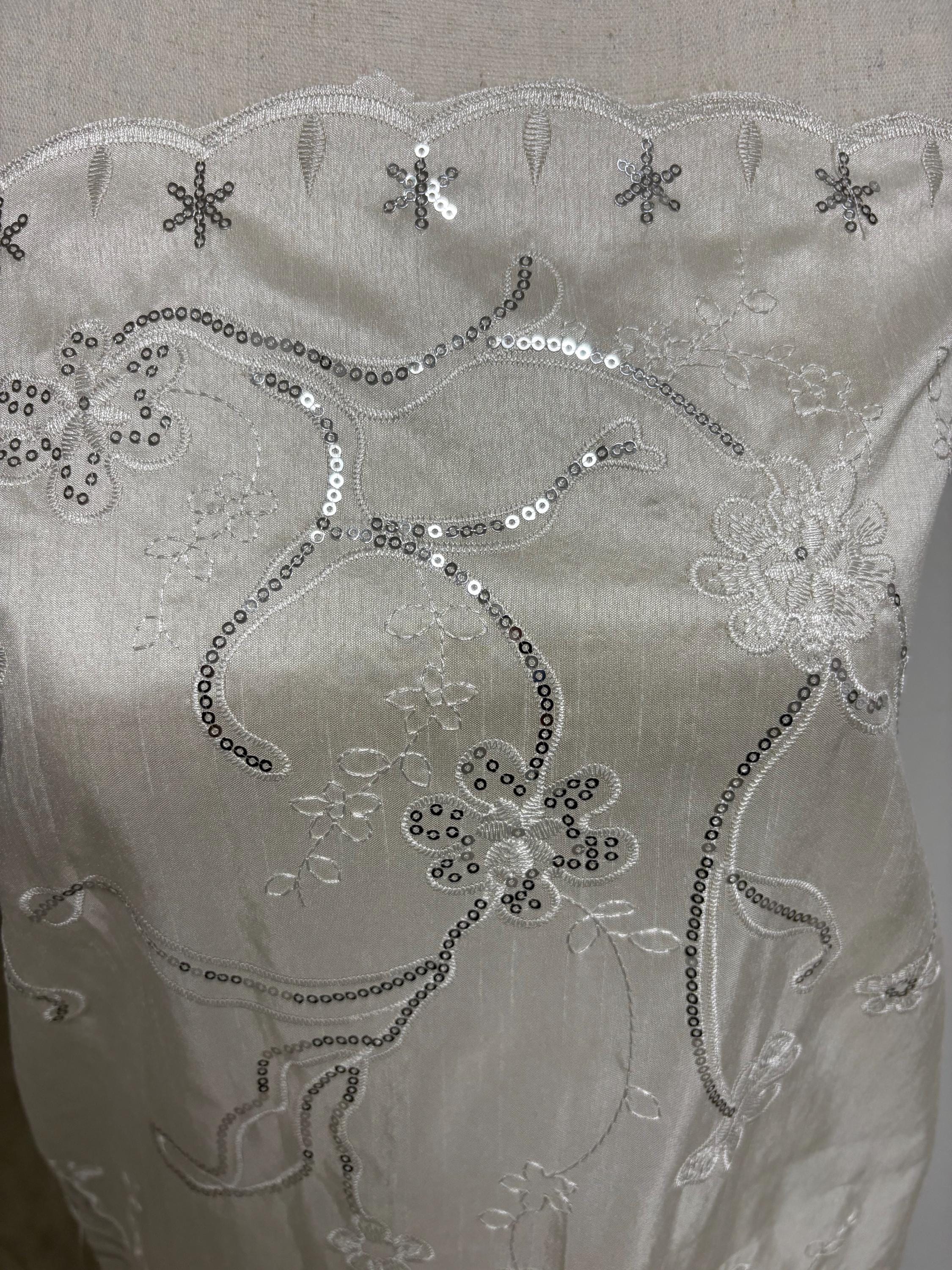 A 3 yards Ivory satin Shantung Fabric width 58 inches polyester. Double scalloped sequins embroidery with slubbed texture.