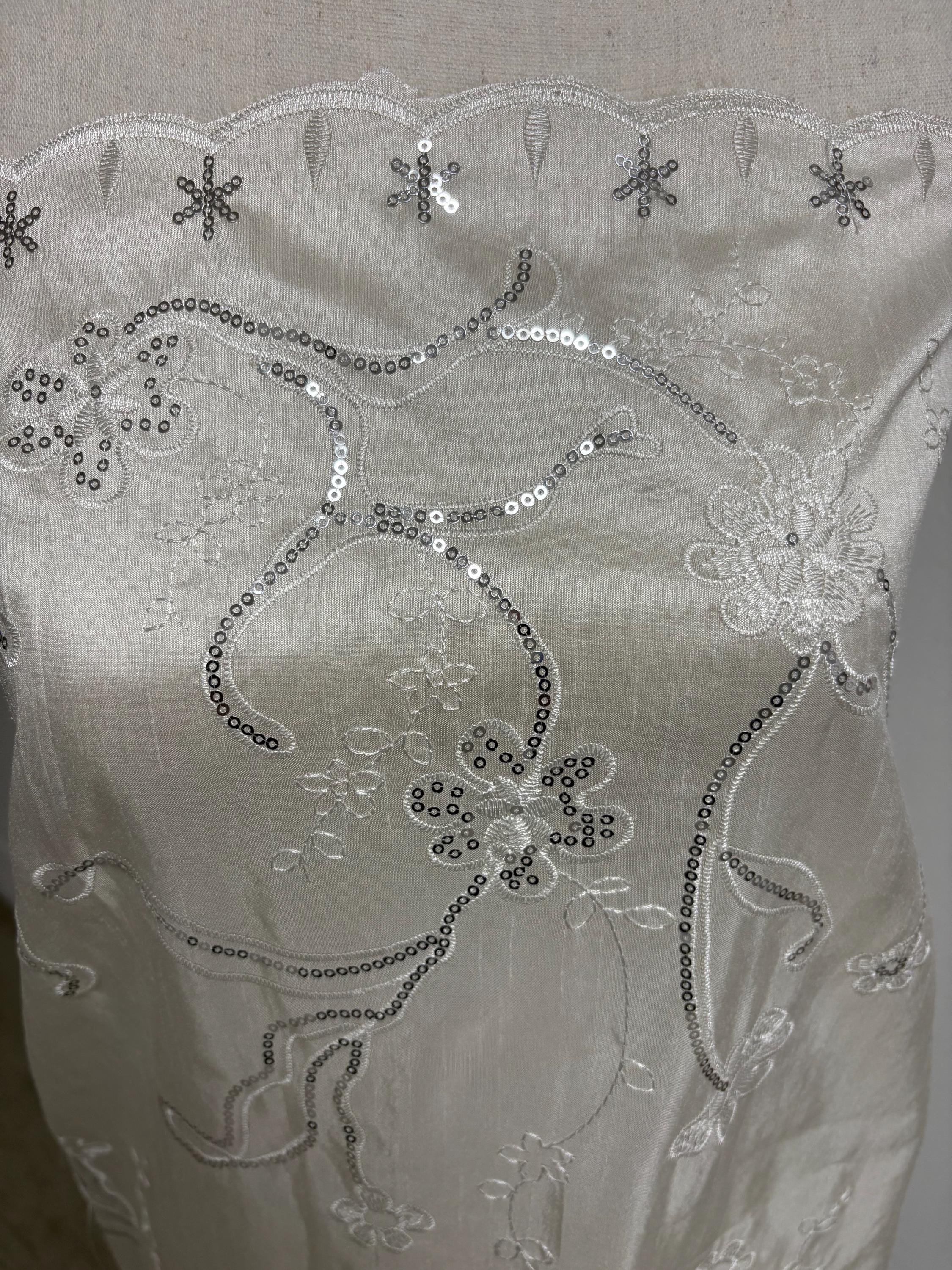 A 3 yards Ivory satin Shantung Fabric width 58 inches polyester. Double scalloped sequins embroidery with slubbed texture.