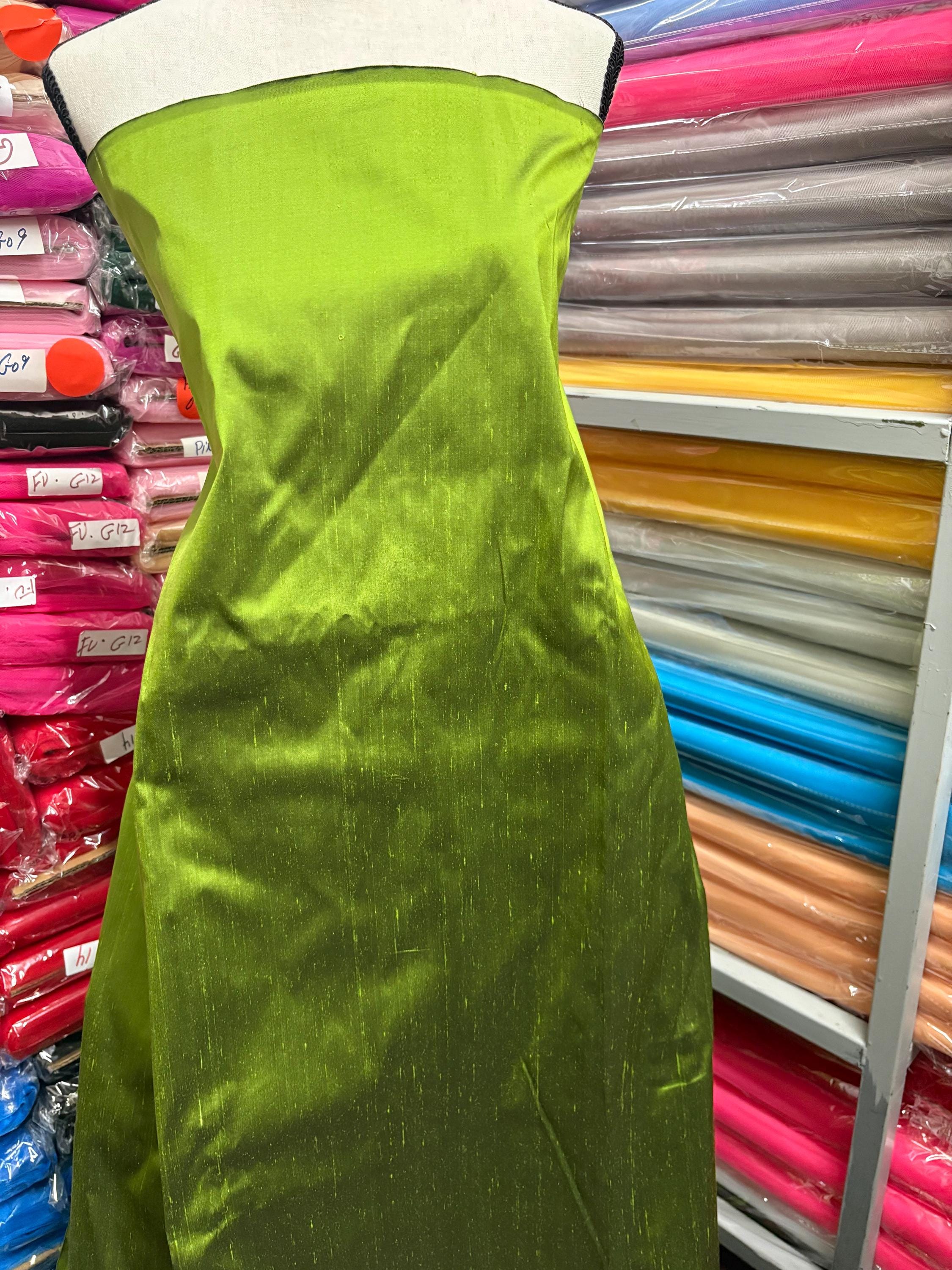 100% silk Dupioni Taffeta width 54" color is two tone Olive with black tone. Machine made, fabric has slubs. Item # 3. free sample.