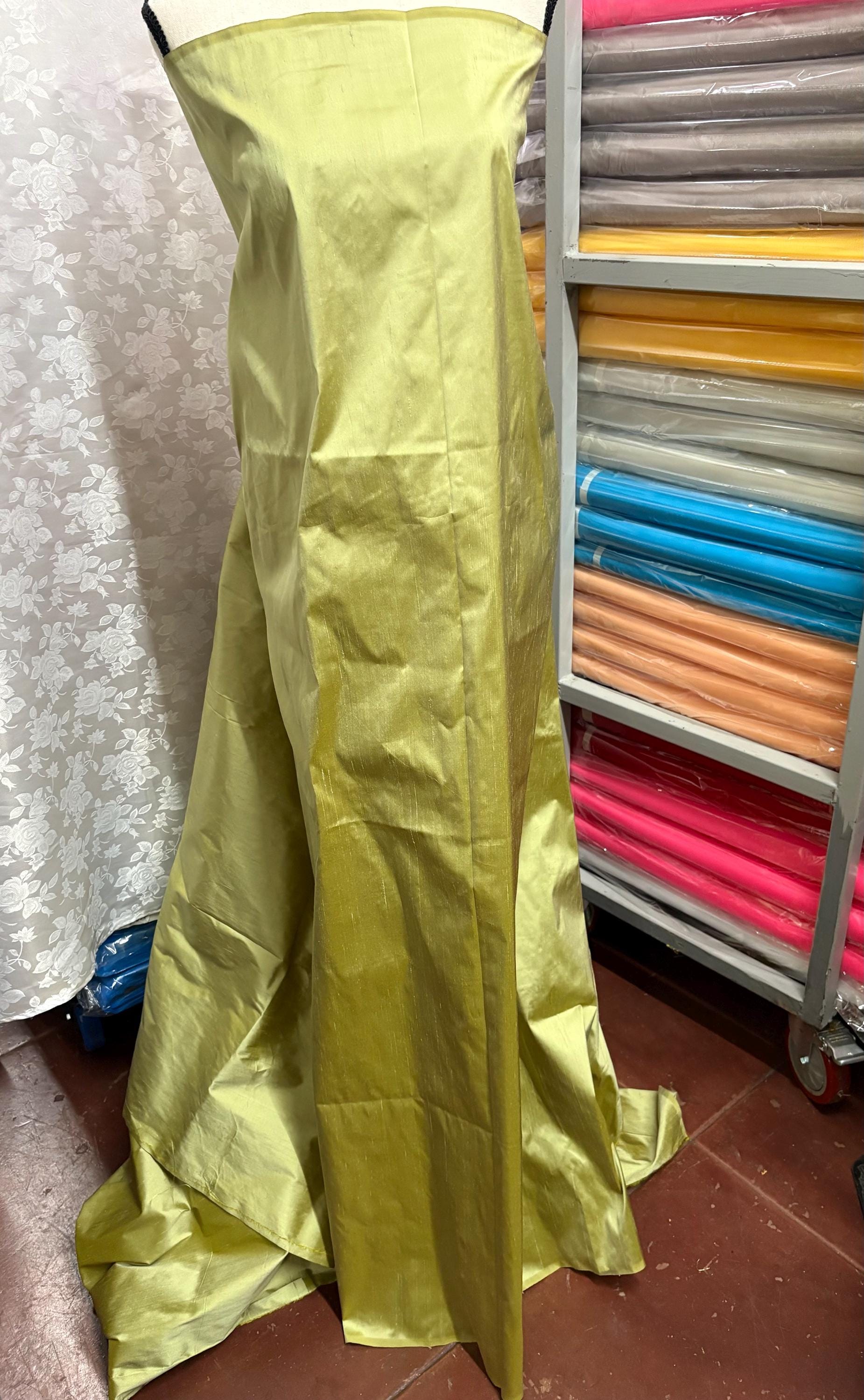 100% silk Dupioni Taffeta width 54" color is Lt. Sage. Machine made, fabric has slubs. Item # 5. free sample.