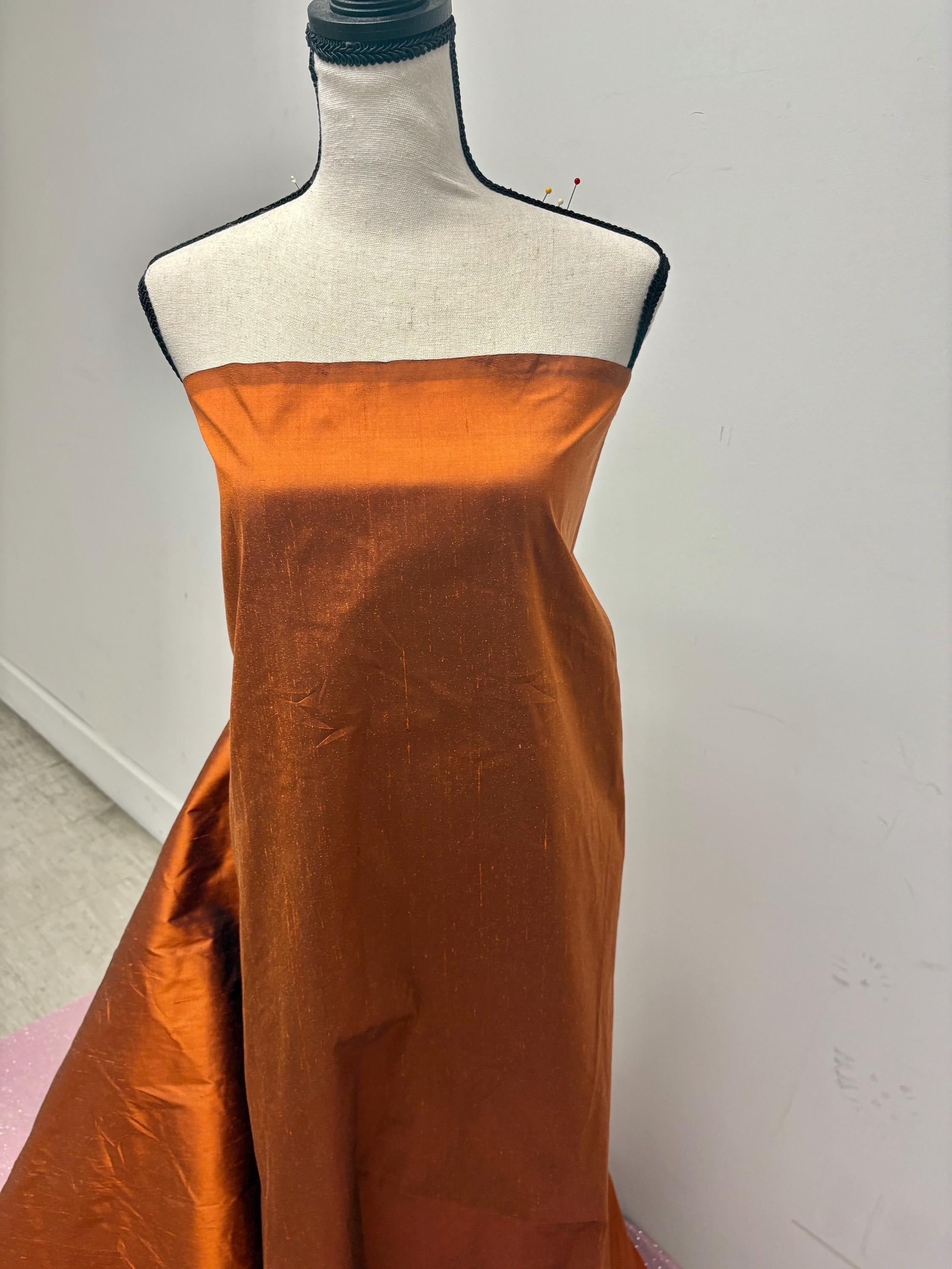 100% silk Dupioni Taffeta width 54" color is Rust with black warp. Machine made, fabric has slubs. Item # 8. free sample. Nas2224-B