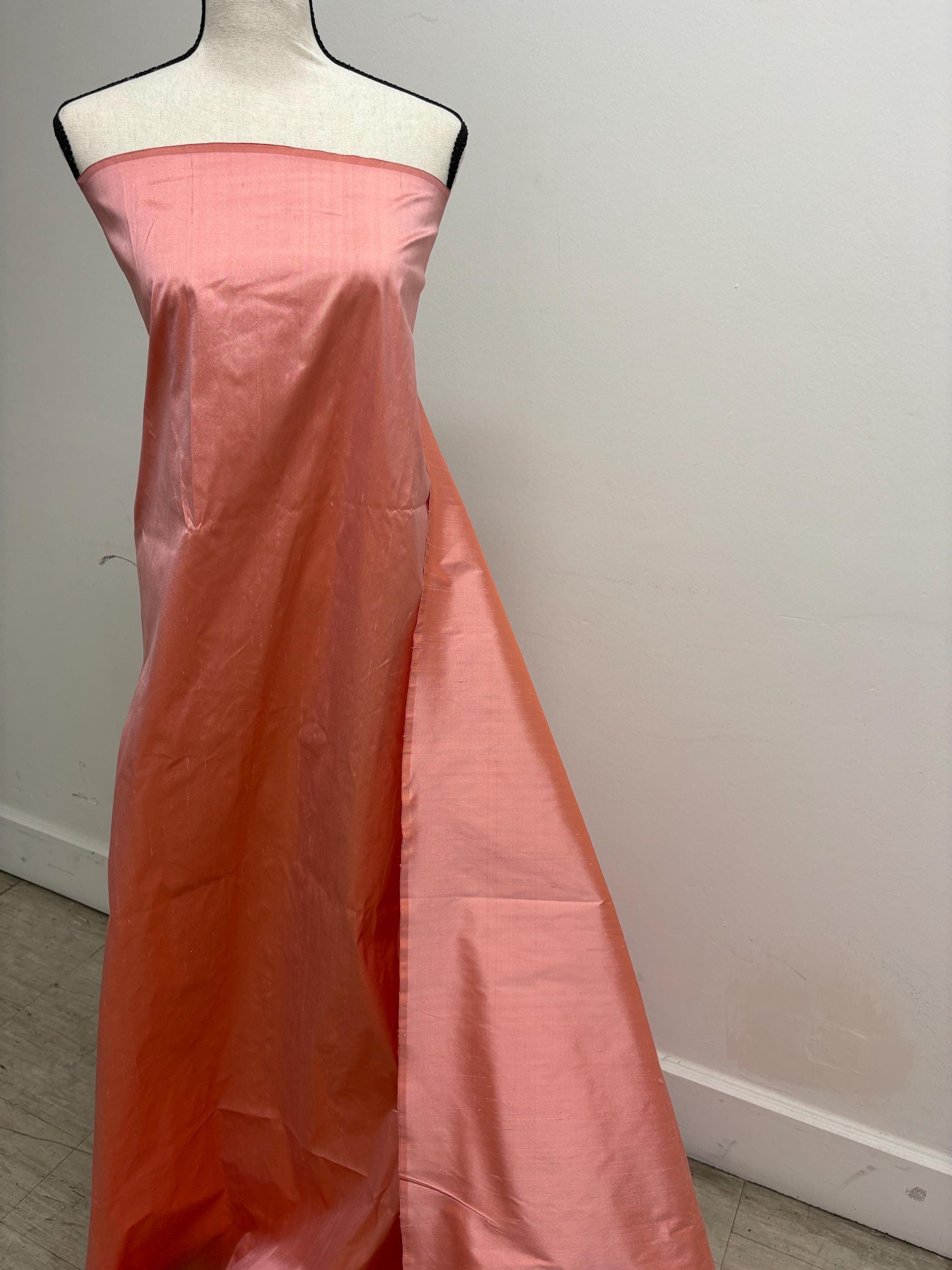 100% silk Dupioni Taffeta width 54" color is Coral. Machine made, fabric has slubs. Item # 12. free sample.
