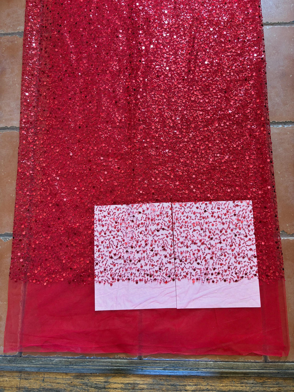 Red Beaded sequence mesh, width of sequence area is 50", plain mesh salvages on both end. item D8-NAS