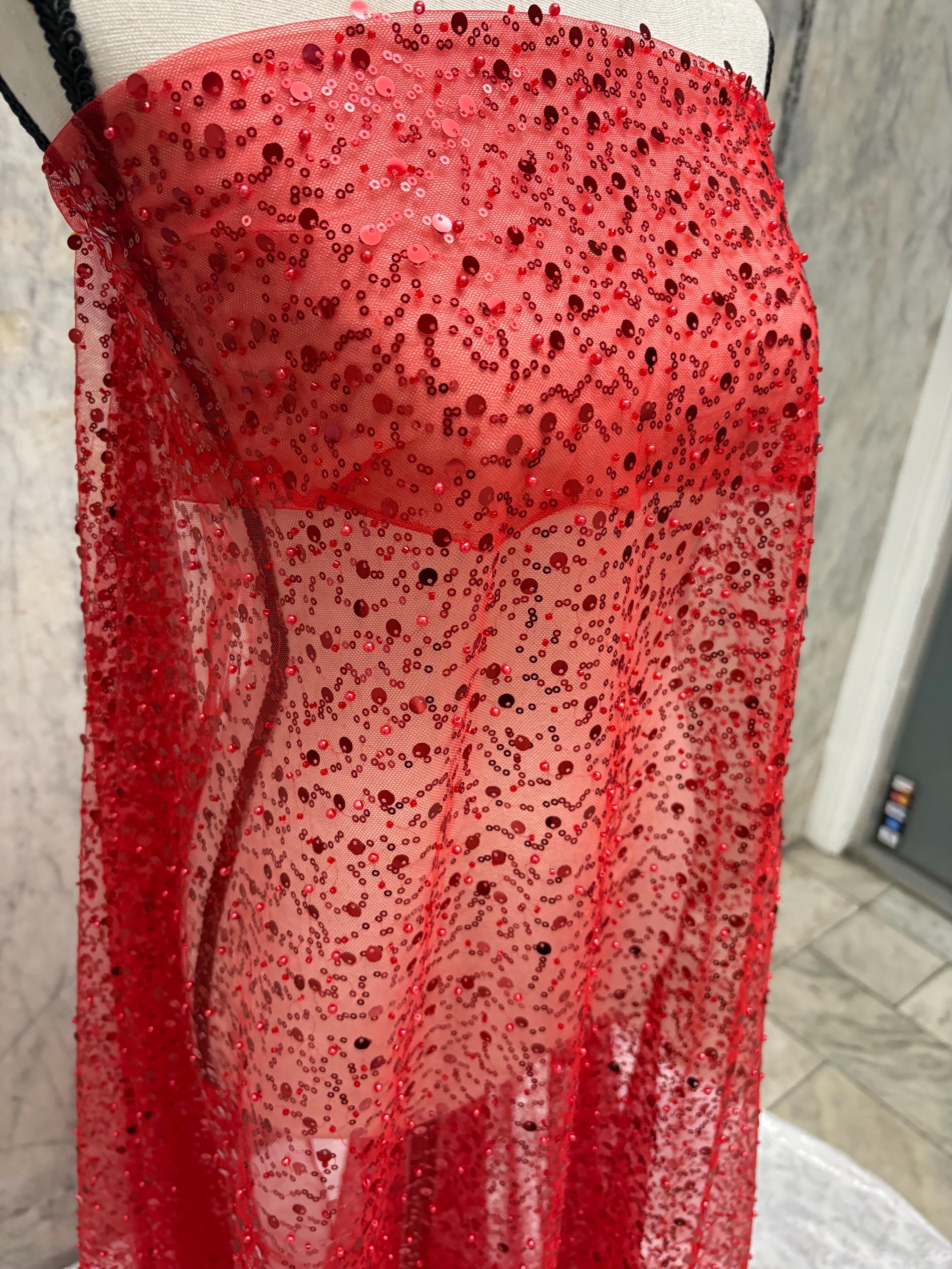 Red Beaded sequence mesh, width of sequence area is 50", plain mesh salvages on both end. item D8-NAS