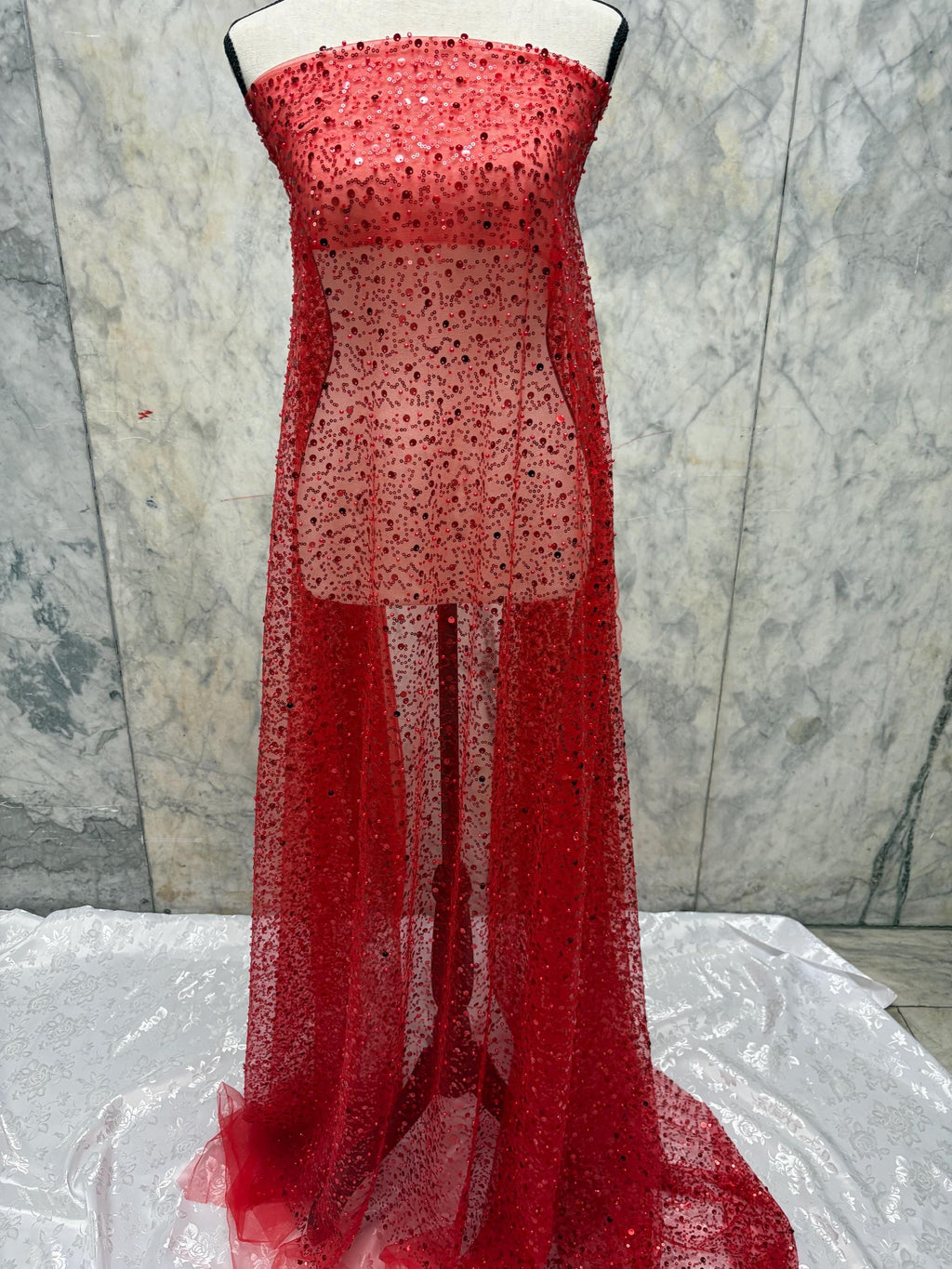 Red Beaded sequence mesh, width of sequence area is 50", plain mesh salvages on both end. item D8-NAS