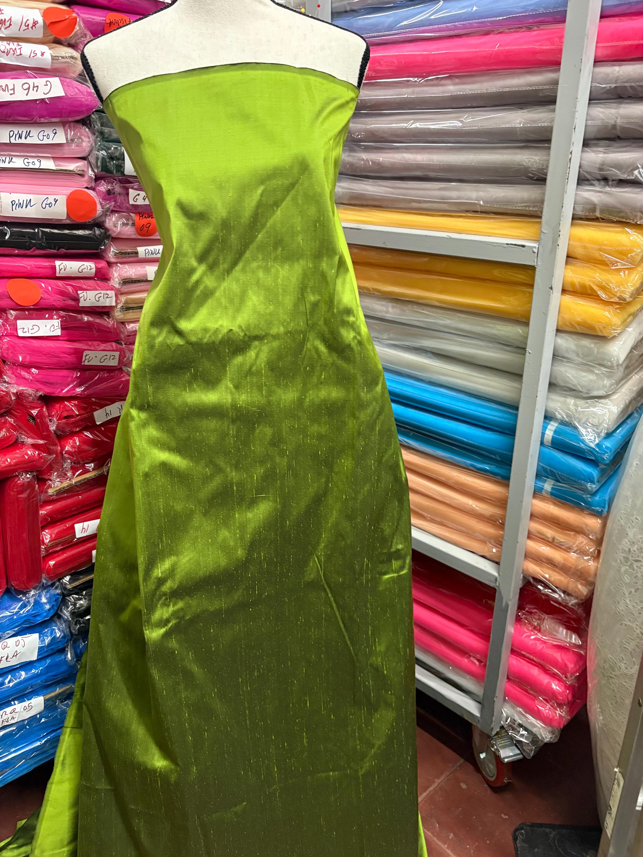100% silk Dupioni Taffeta width 54" color is two tone Olive with black tone. Machine made, fabric has slubs. Item # 3. free sample.