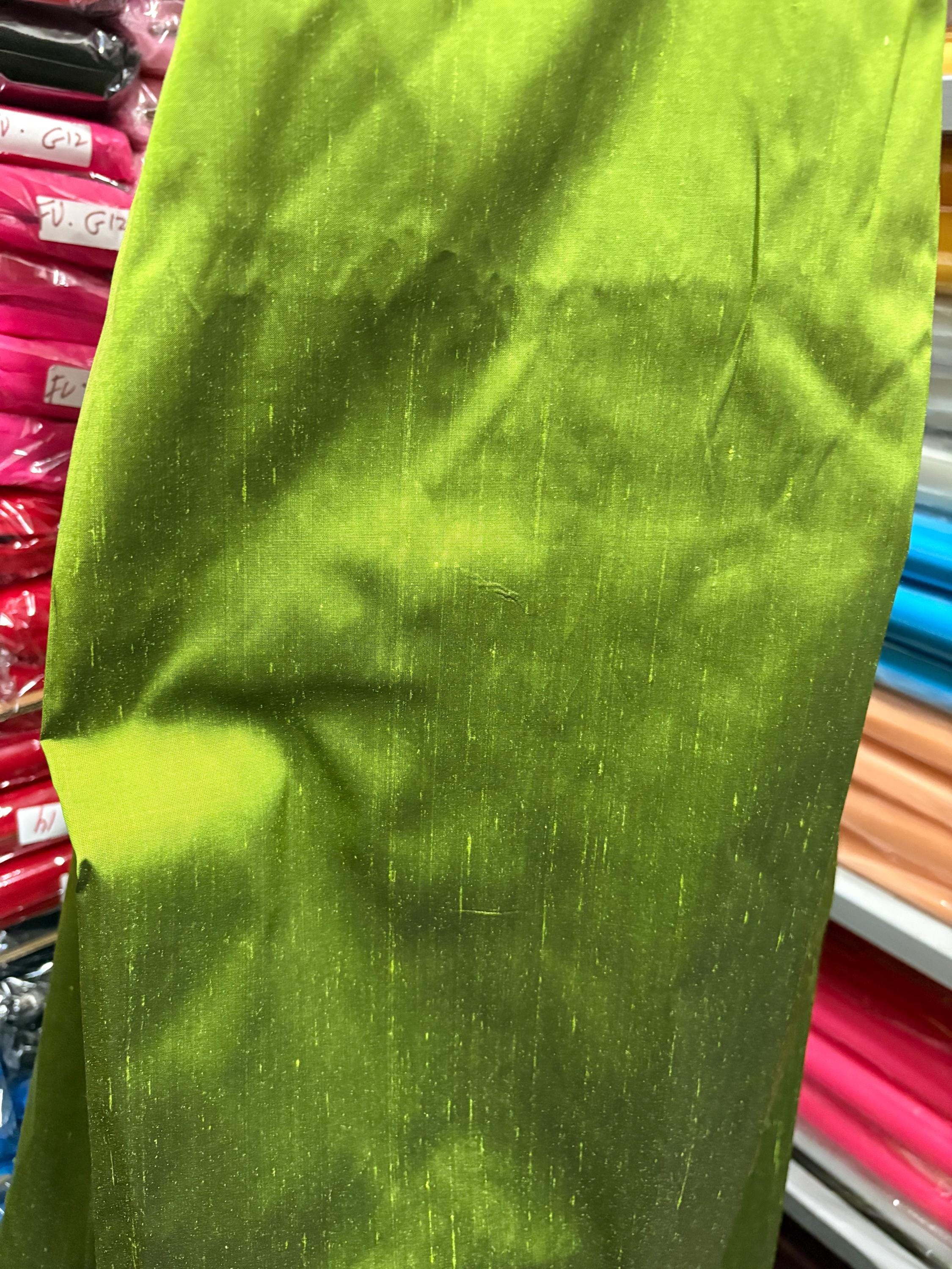 100% silk Dupioni Taffeta width 54" color is two tone Olive with black tone. Machine made, fabric has slubs. Item # 3. free sample.