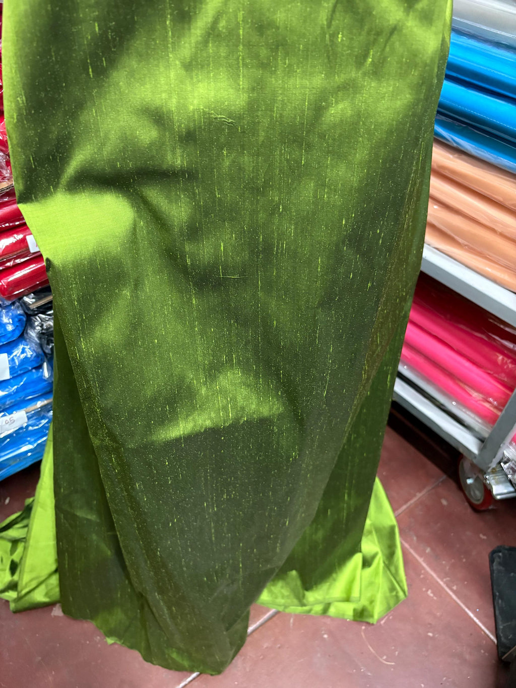 100% silk Dupioni Taffeta width 54" color is two tone Olive with black tone. Machine made, fabric has slubs. Item # 3. free sample.