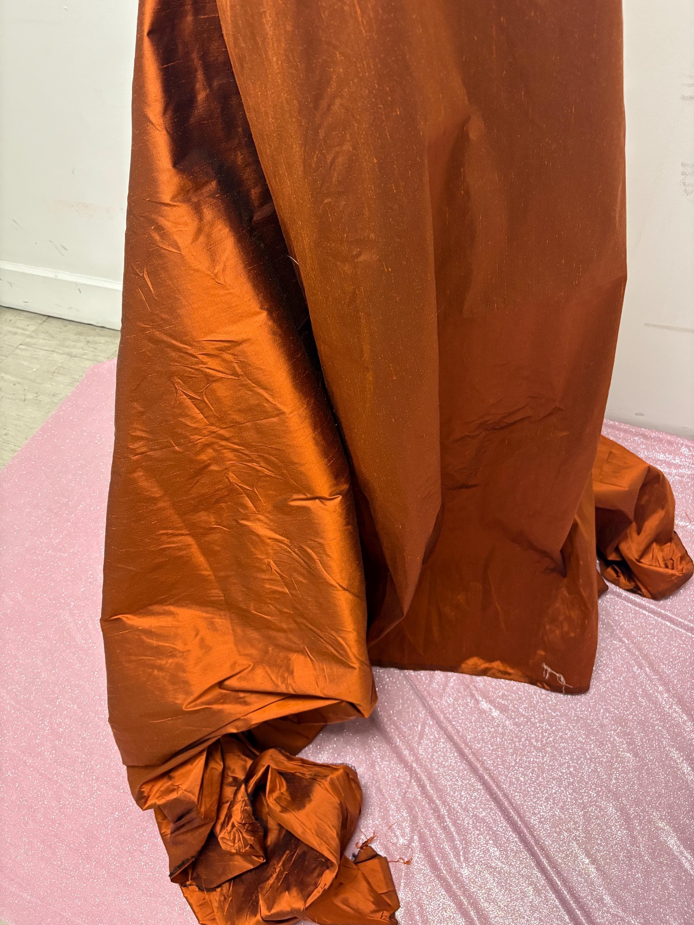 100% silk Dupioni Taffeta width 54" color is Rust with black warp. Machine made, fabric has slubs. Item # 8. free sample. Nas2224-B