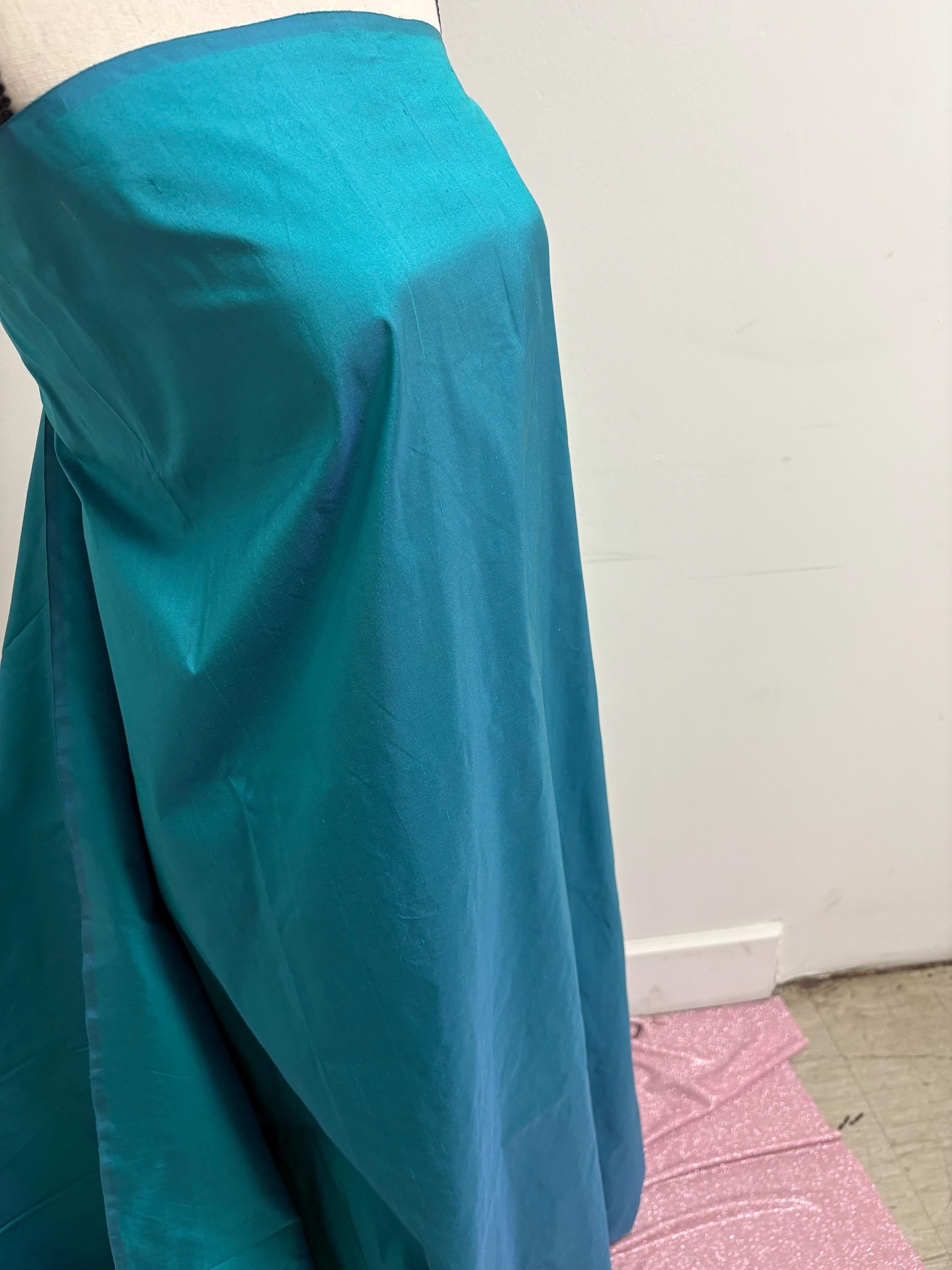 100% silk Dupioni Taffeta width 54" color is Turquoise. Machine made, fabric has slubs. Item # 10. free sample.