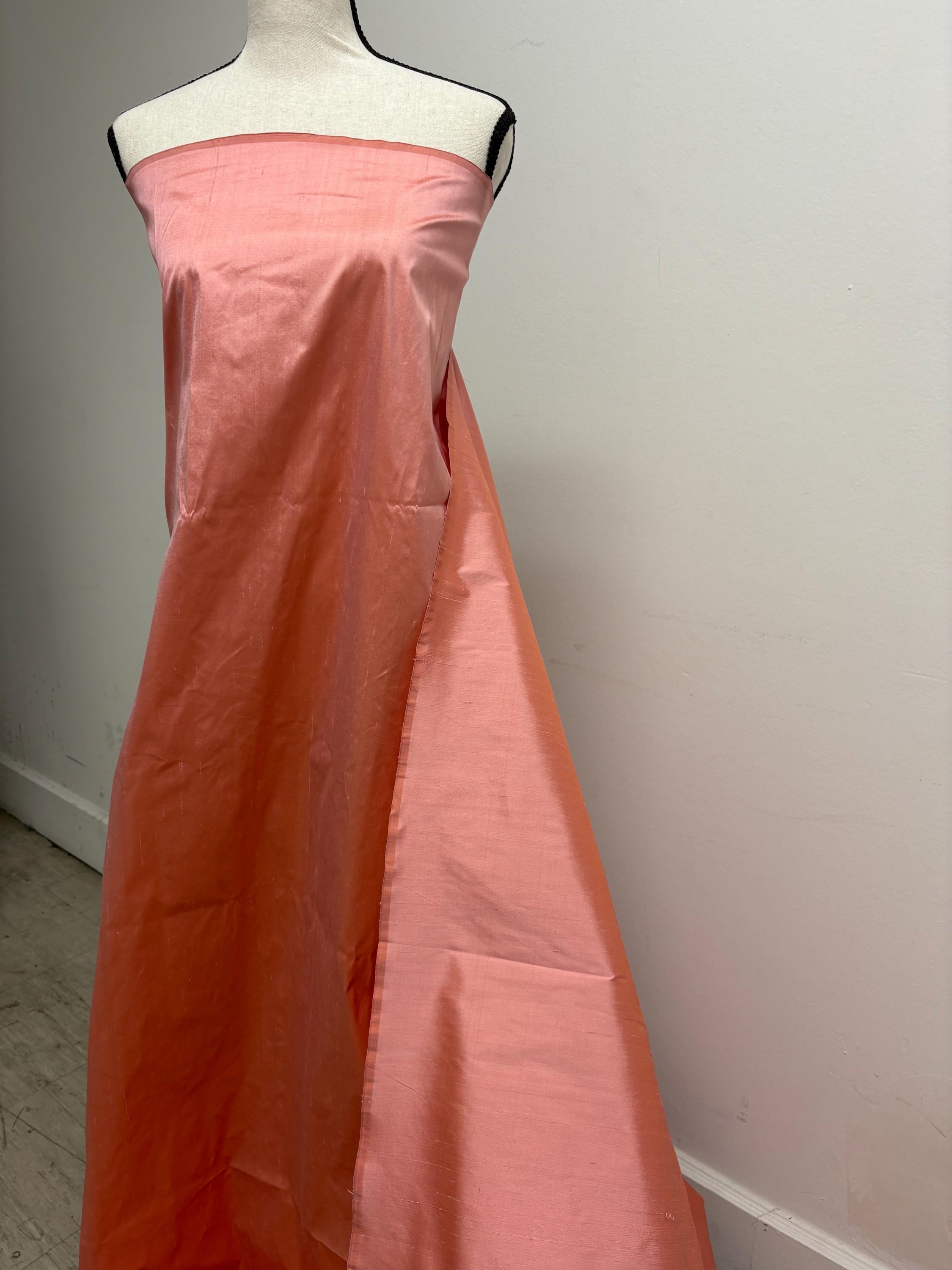 100% silk Dupioni Taffeta width 54" color is Coral. Machine made, fabric has slubs. Item # 12. free sample.