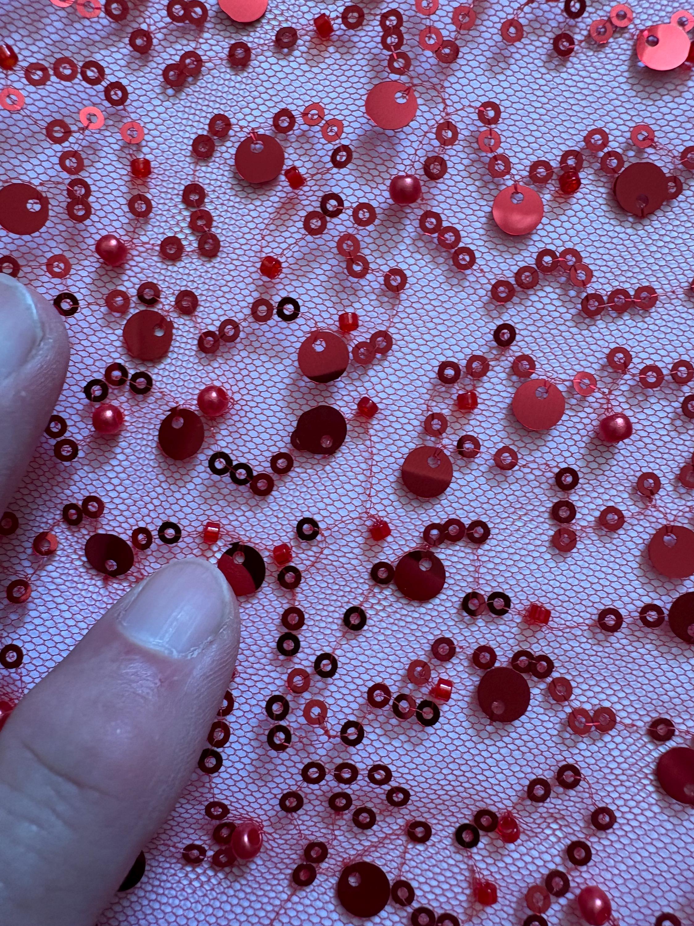 Red Beaded sequence mesh, width of sequence area is 50", plain mesh salvages on both end. item D8-NAS