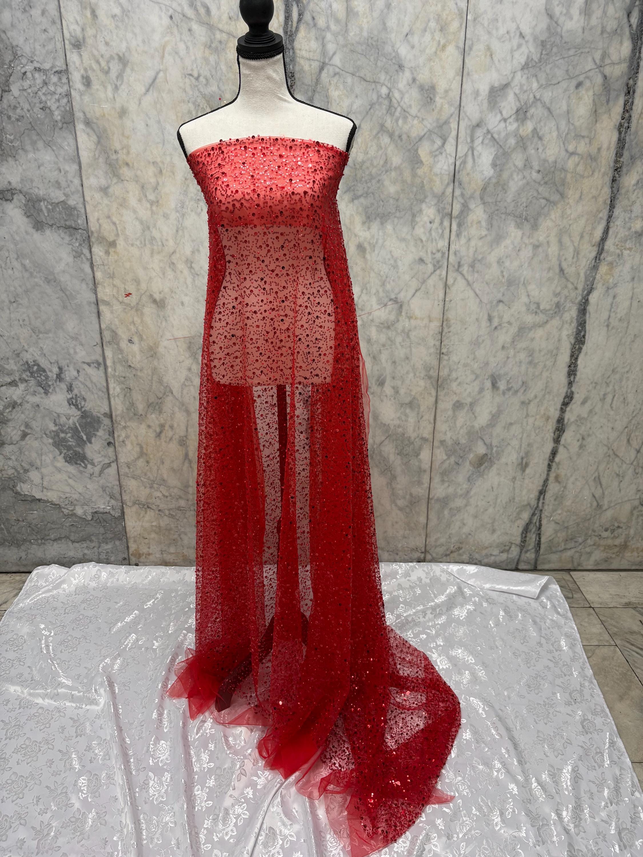Red Beaded sequence mesh, width of sequence area is 50", plain mesh salvages on both end. item D8-NAS