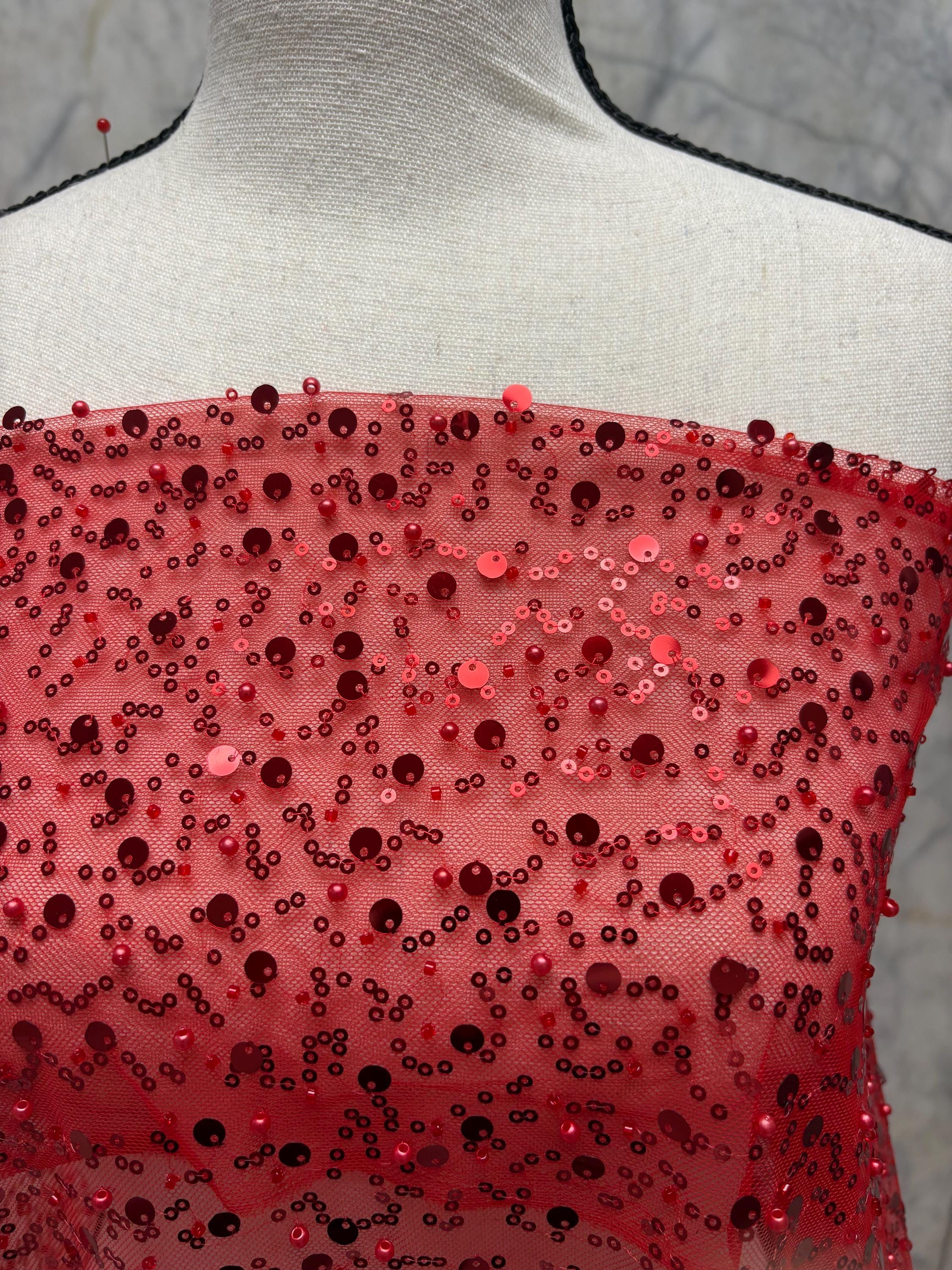 Red Beaded sequence mesh, width of sequence area is 50", plain mesh salvages on both end. item D8-NAS
