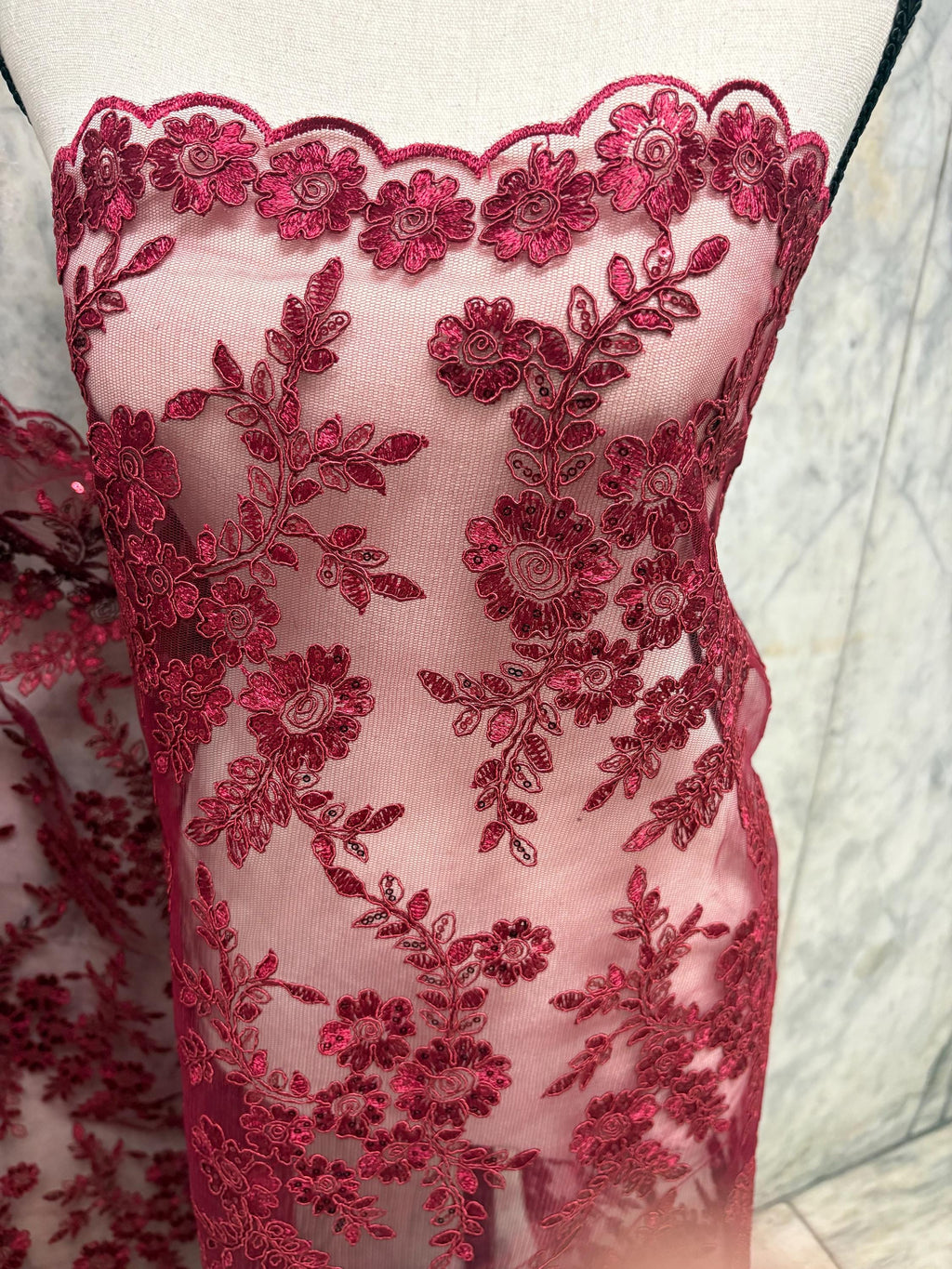 Burgundy Lace fabric design bloom 6 width 49". Double scalloped embroidery sequence.