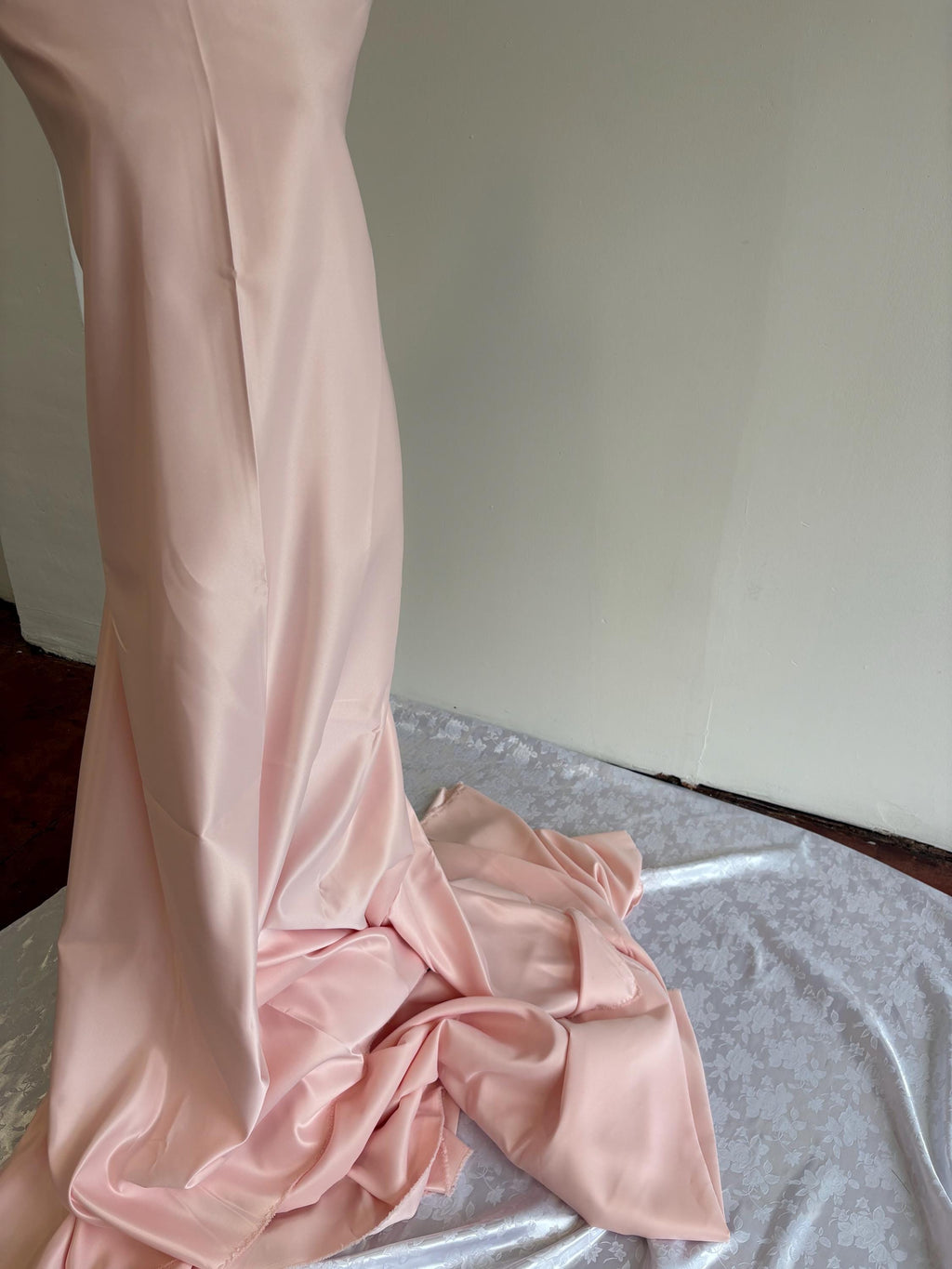 Light pink dull satin fabric, 58/60” wide, made of polyester – an excellent choice for gowns.