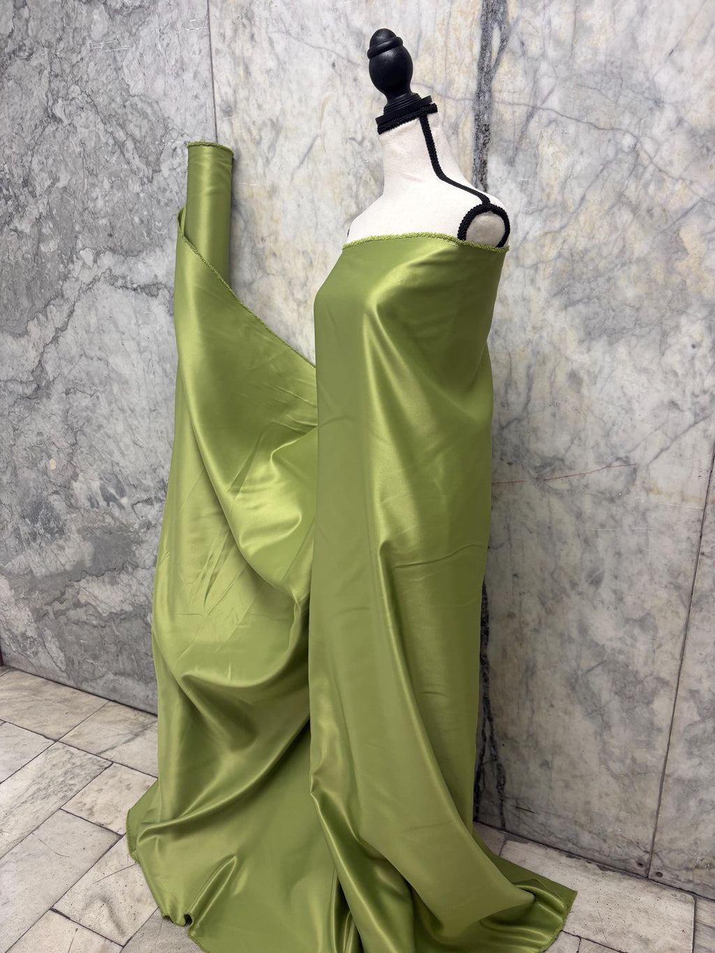 Green dull satin fabric, 58/60” wide, made of polyester – an excellent choice for gowns.