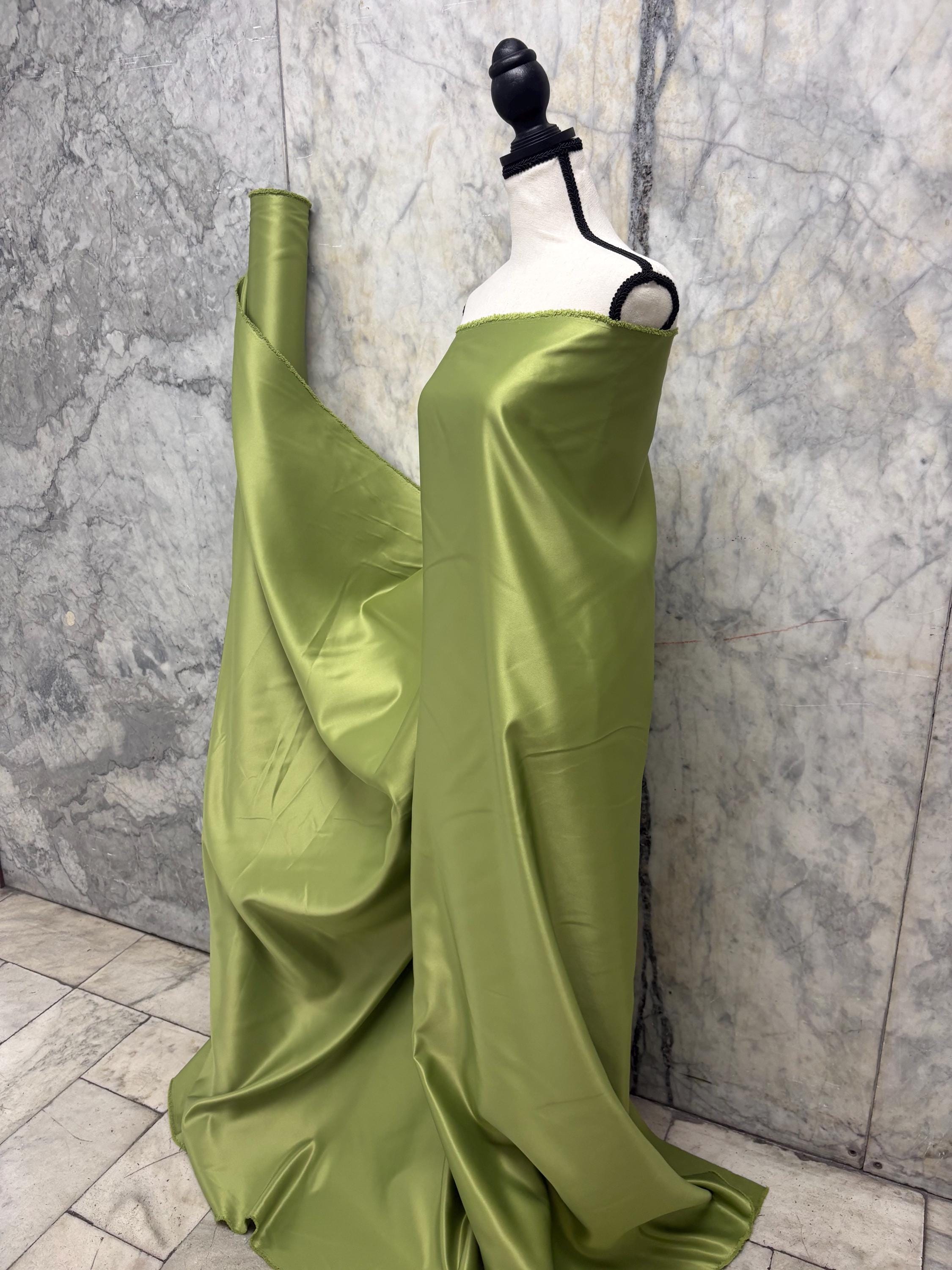 Green dull satin fabric, 58/60” wide, made of polyester – an excellent choice for gowns.