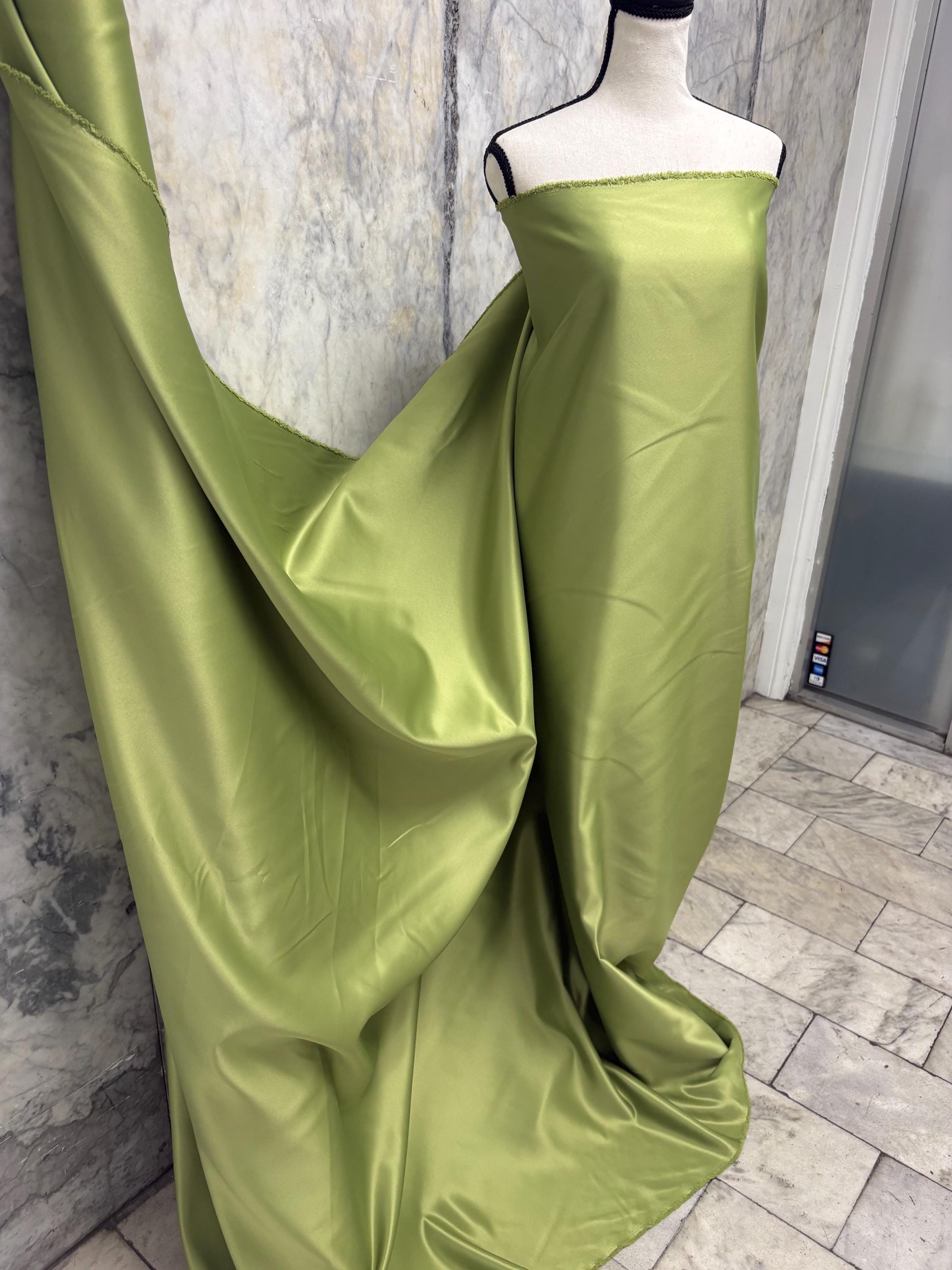 Green dull satin fabric, 58/60” wide, made of polyester – an excellent choice for gowns.