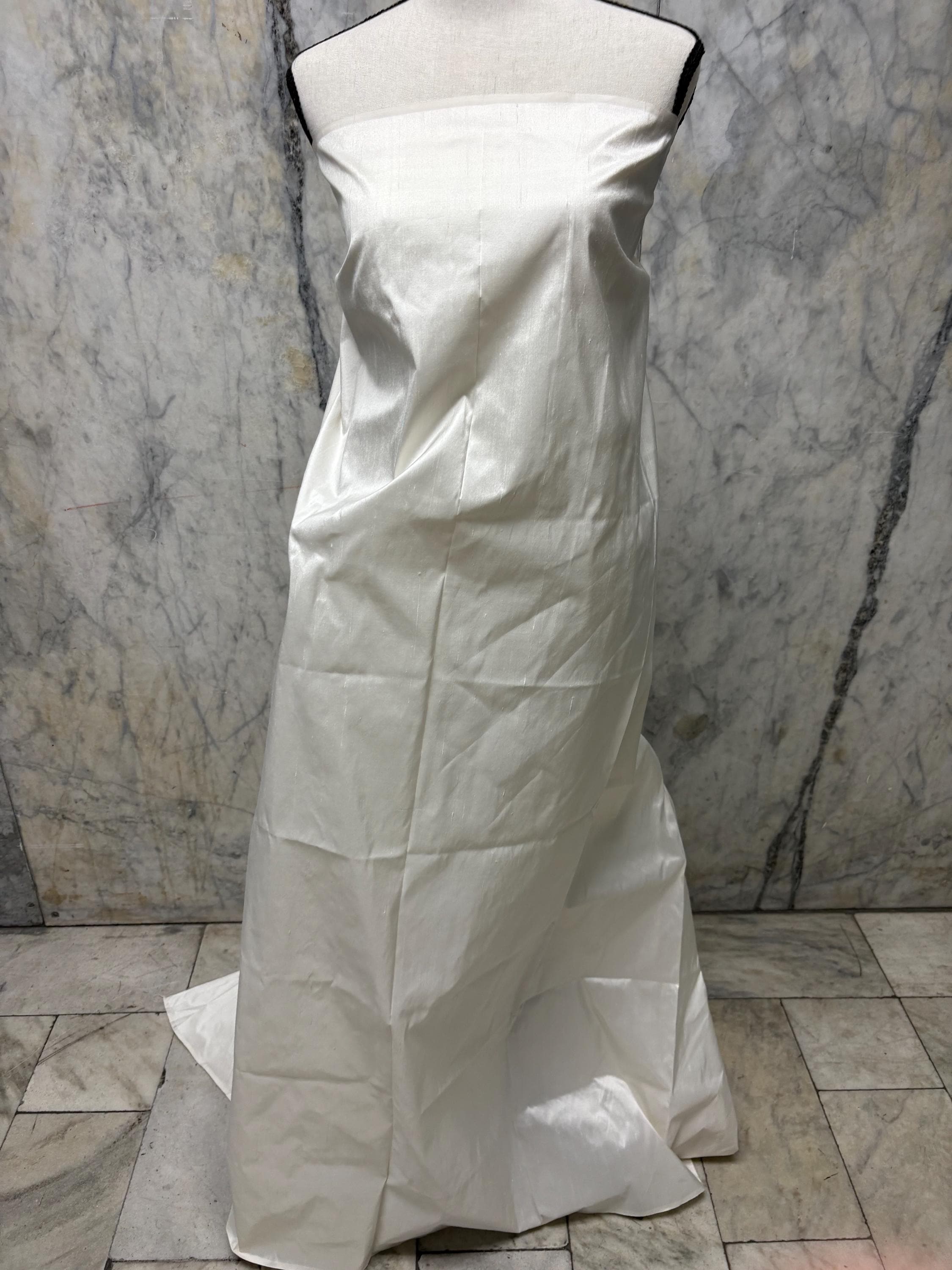 100% silk Dupioni Taffeta width 54" color Light ivory. Machine made, fabric has slubs. Free sample. shop with confidence. item# 1199