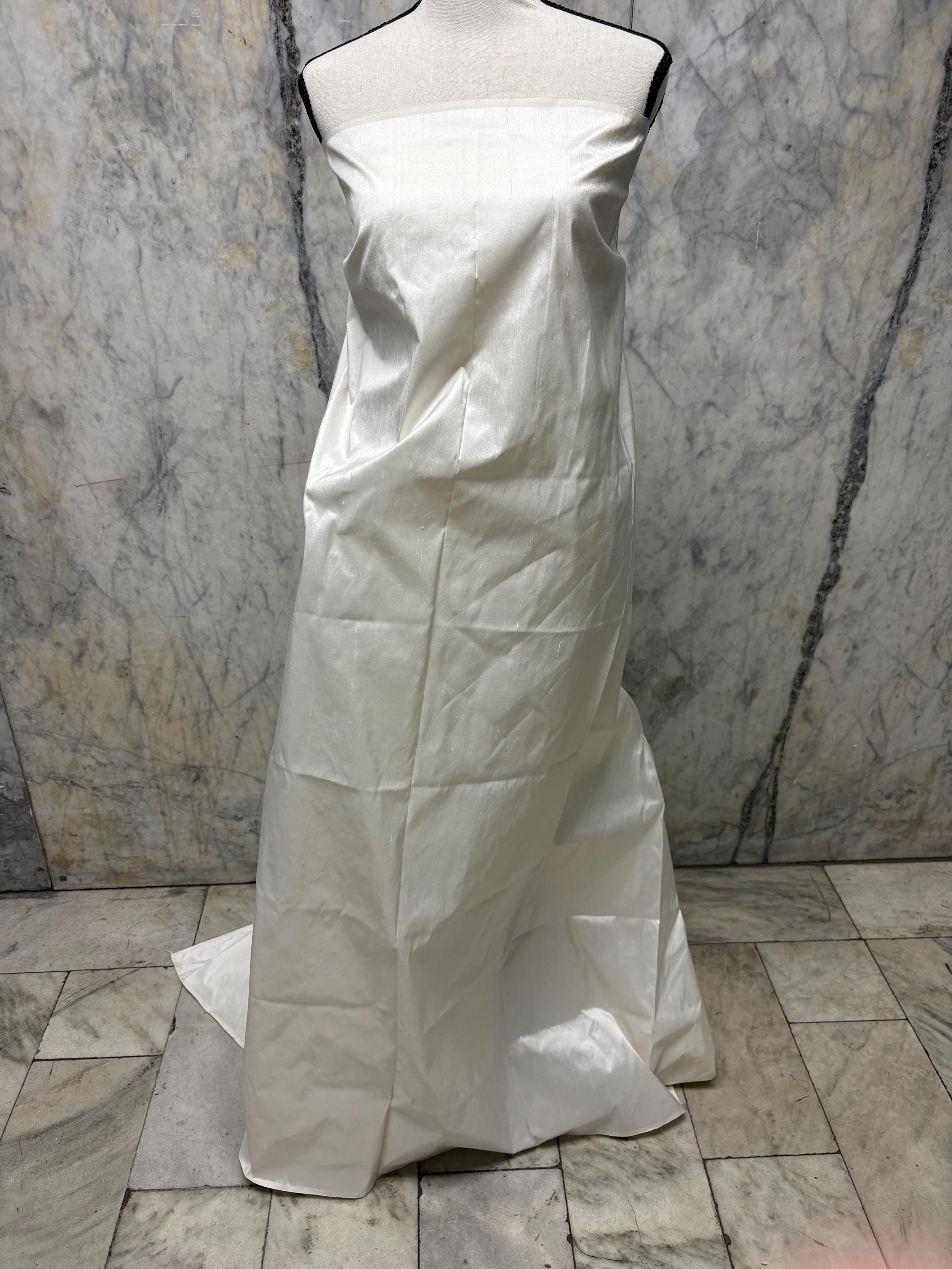 100% silk Dupioni Taffeta width 54" color Light ivory. Machine made, fabric has slubs. Free sample. shop with confidence. item# 1199