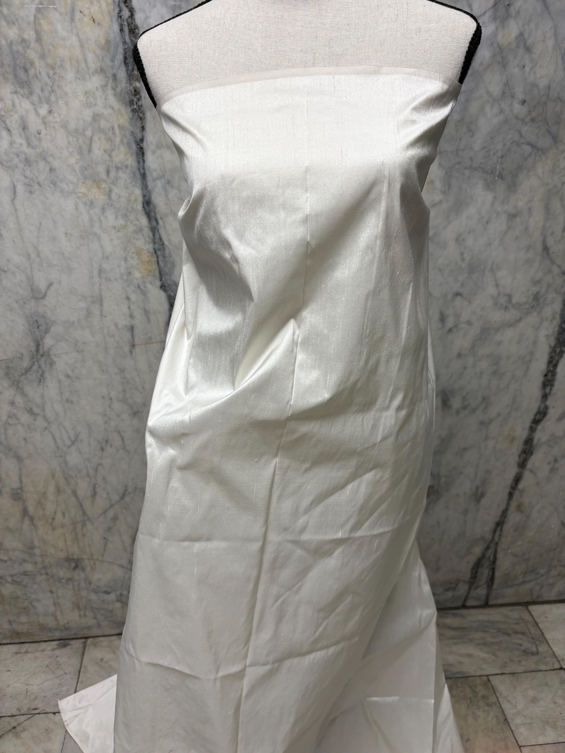 100% silk Dupioni Taffeta width 54" color Light ivory. Machine made, fabric has slubs. Free sample. shop with confidence. item# 1199