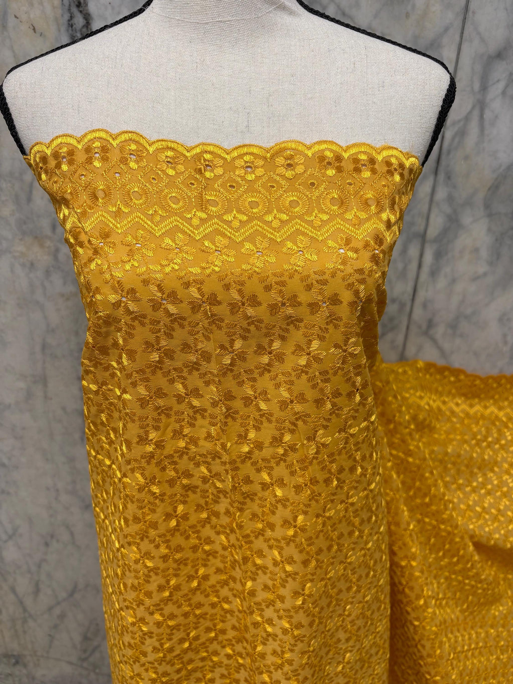 Eyelet fabric made of poly-cotton with all-over embroidery and double scalloped edges for a delicate finish. color Gold design # 2