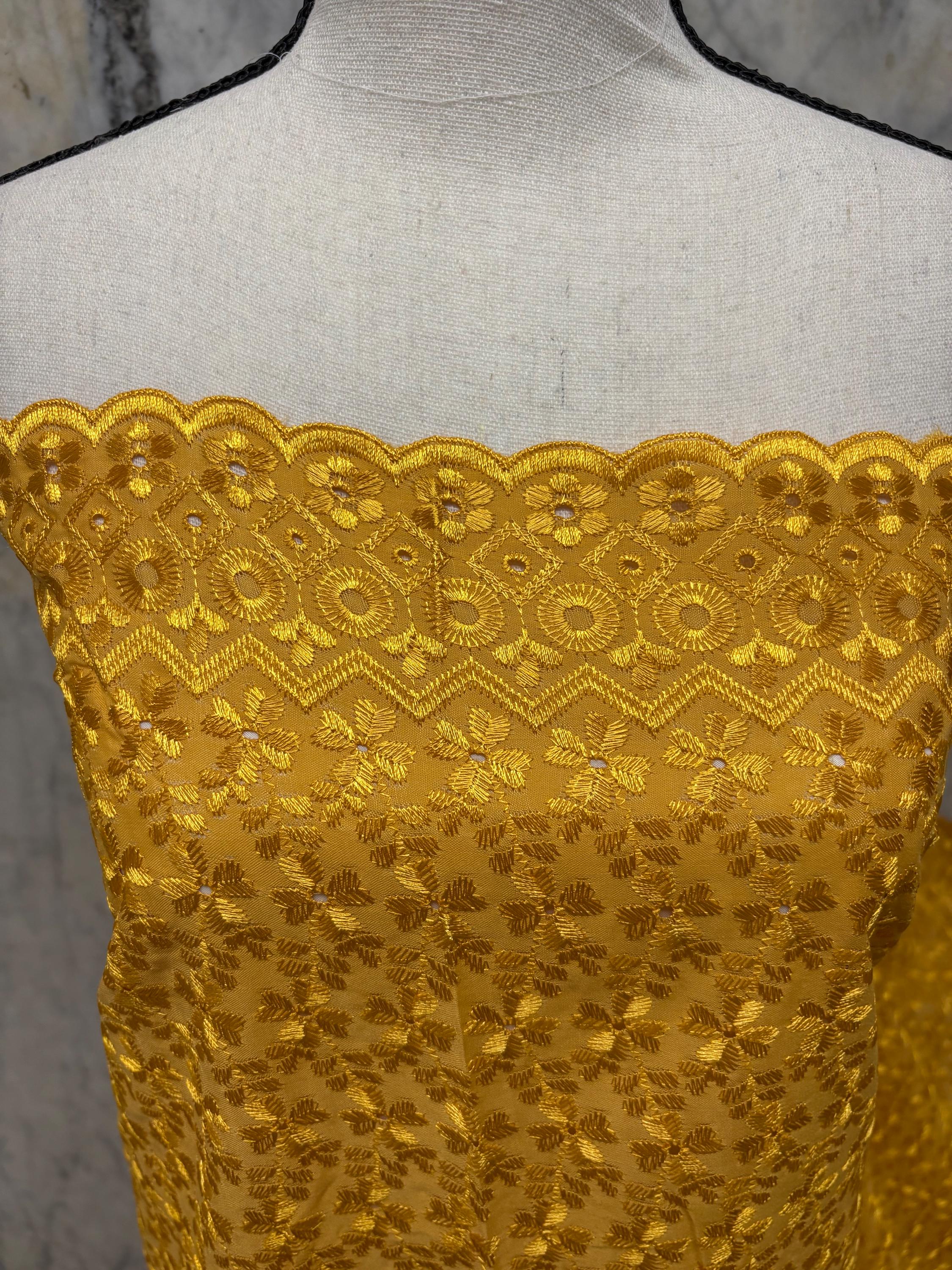 Eyelet fabric made of poly-cotton with all-over embroidery and double scalloped edges for a delicate finish. color Gold design # 2