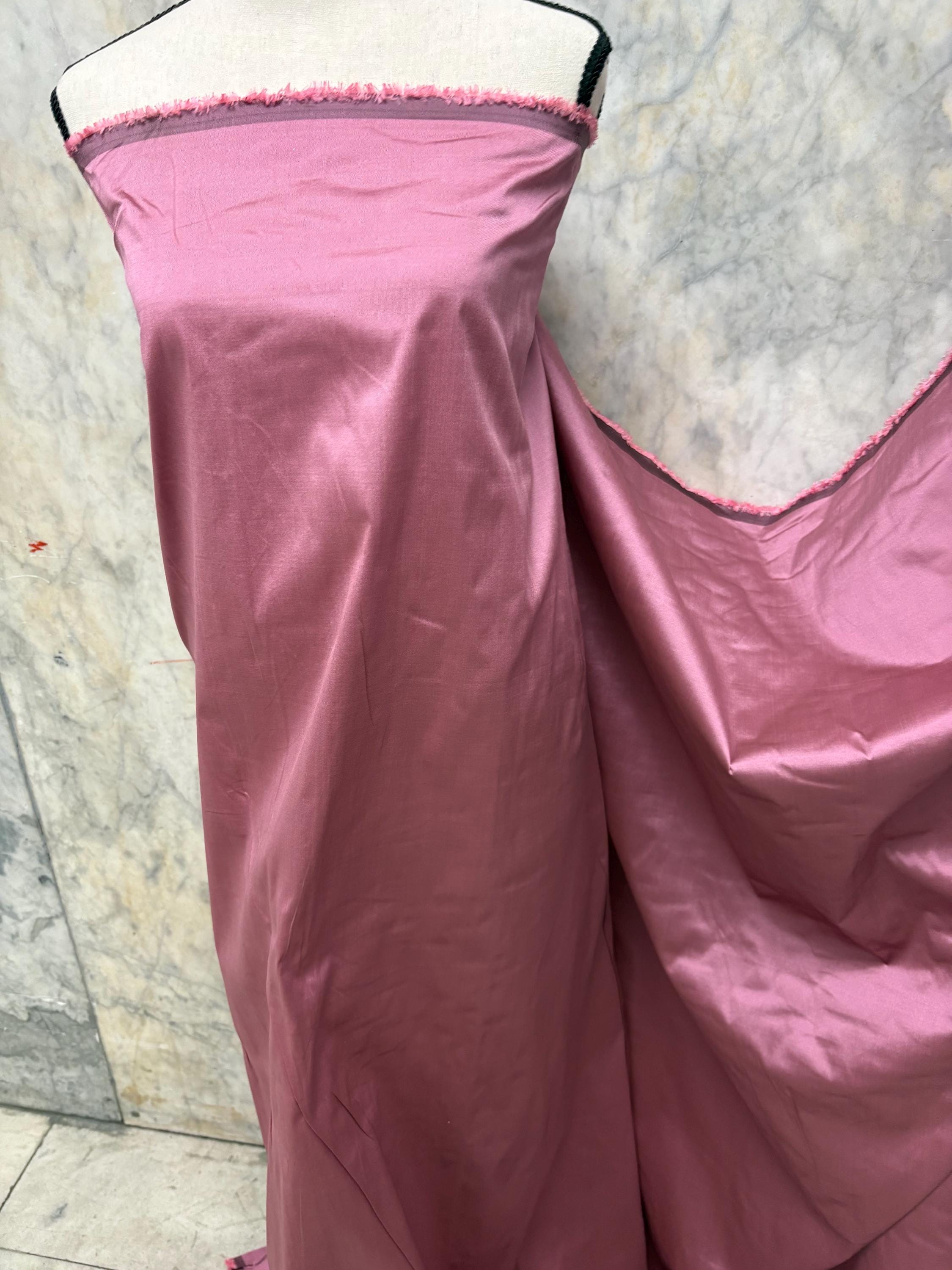 2-yard cut of rust taffeta fabric, 58" wide, polyester. Features a black undertone, perfect for party dresses and formal wear.