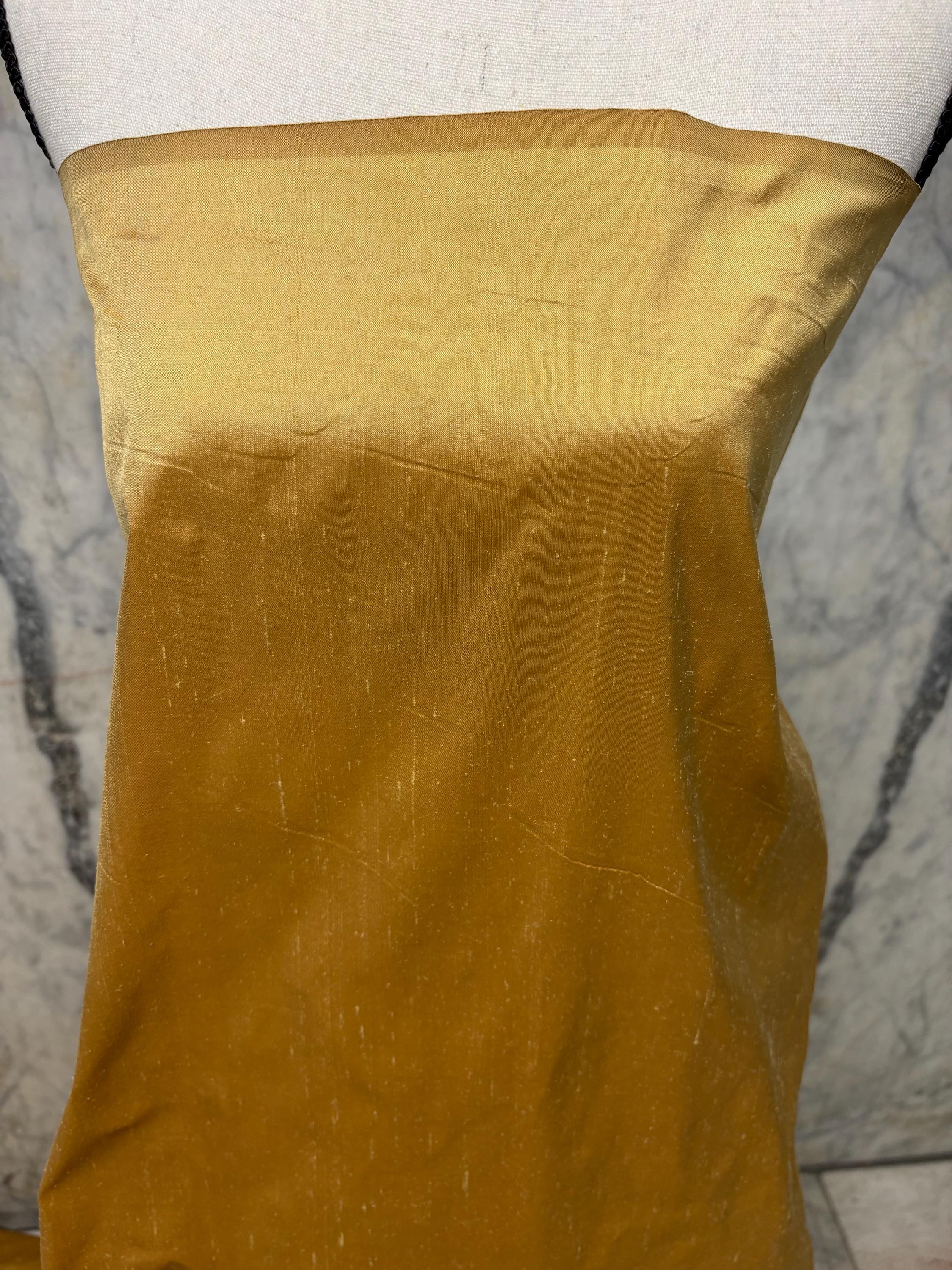 100% silk Taffeta fabric width 54" color is gold. Machine made, fabric has slubs. Free sample. Nas2217 A
