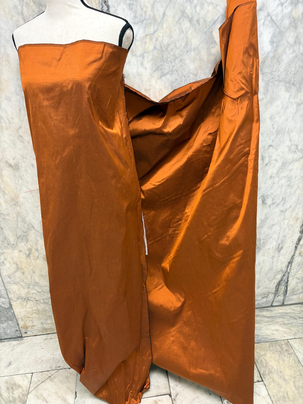 100% silk Dupioni Taffeta width 54" color is Rust with black warp. Machine made, fabric has slubs. Item # 8. free sample. Nas2224-B