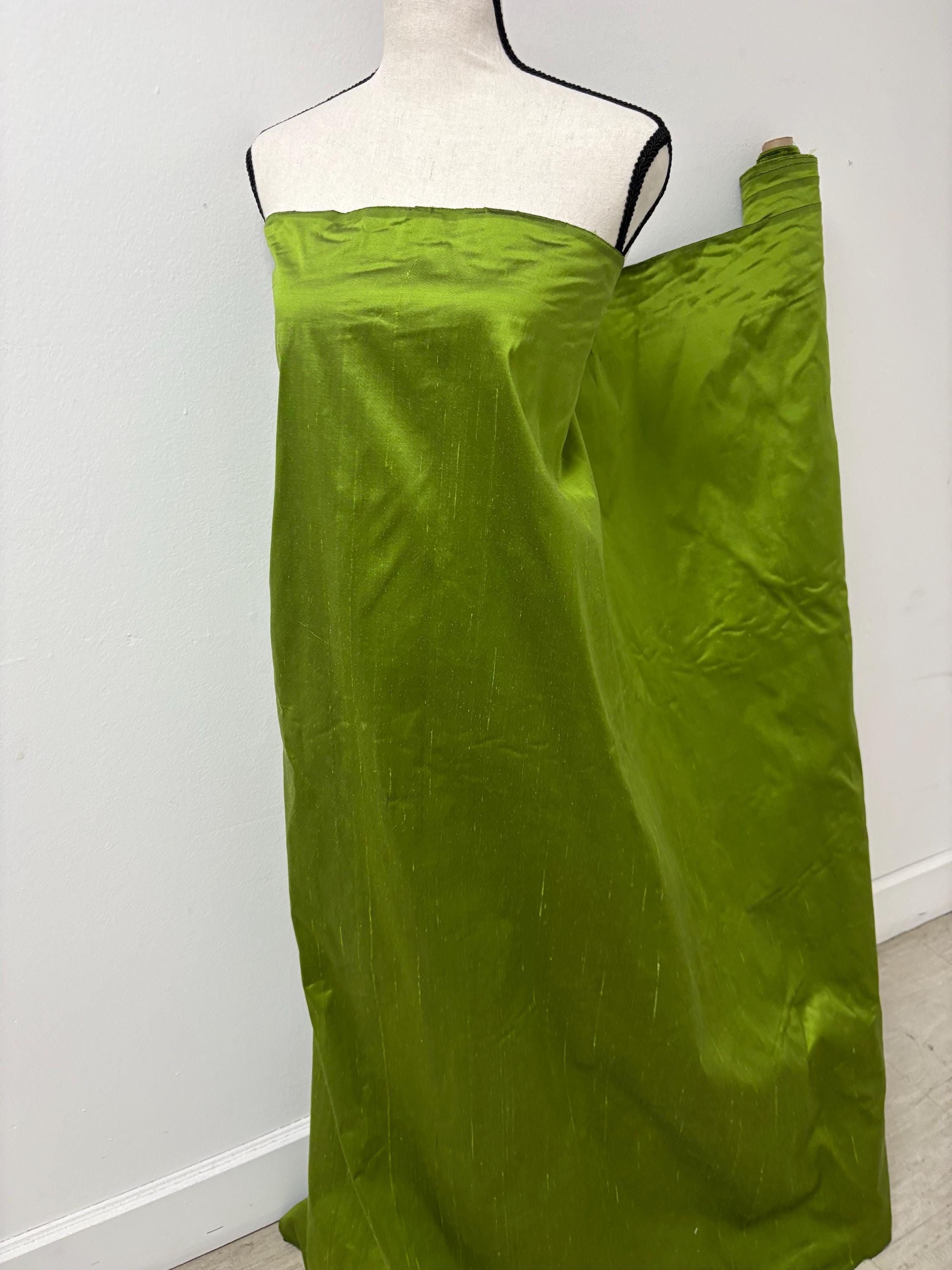 100% silk Dupioni Taffeta width 54" color is Lime with black warp. Machine made, fabric has slubs. free sample. Nas2244