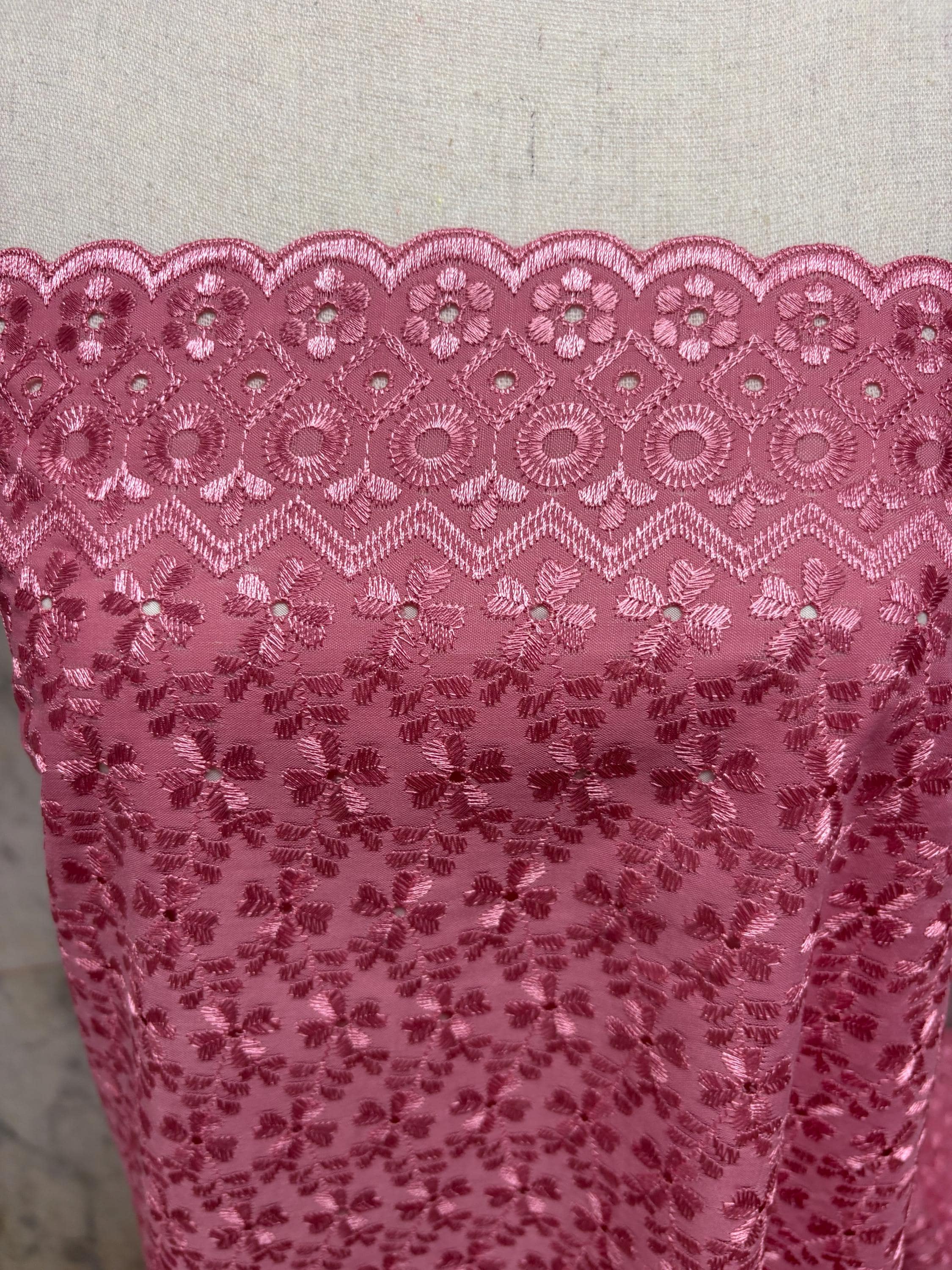 Eyelet fabric made of poly-cotton with all-over embroidery and double scalloped edges for a delicate finish. color Mauve design # 2