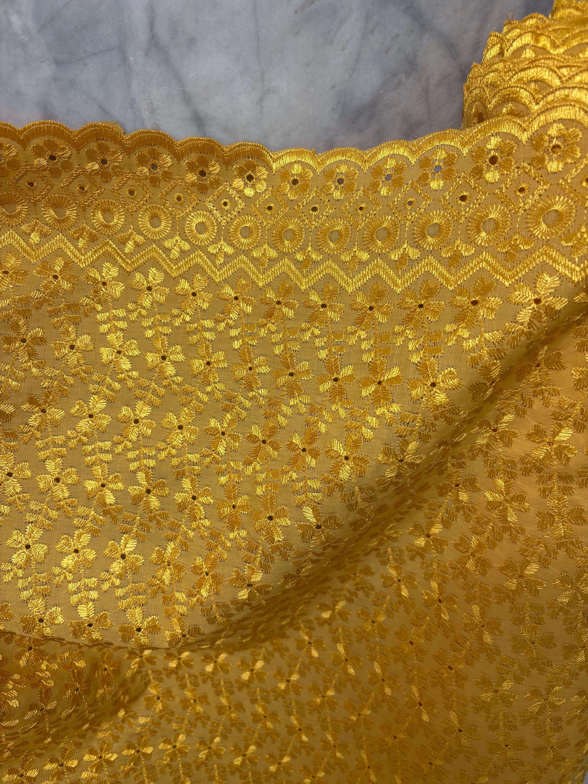 Eyelet fabric made of poly-cotton with all-over embroidery and double scalloped edges for a delicate finish. color Gold design # 2